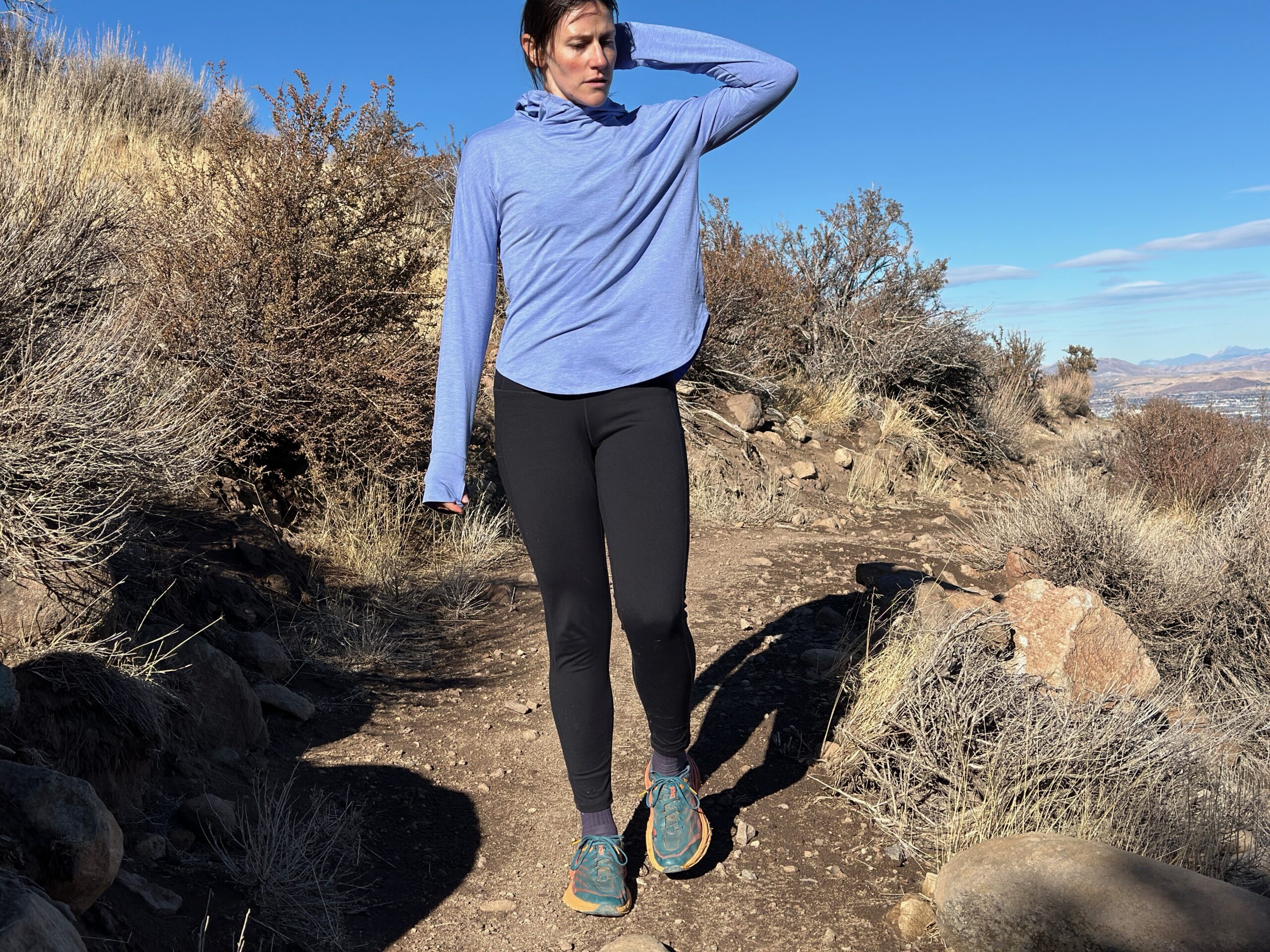 woman hiking in high desert with dog
