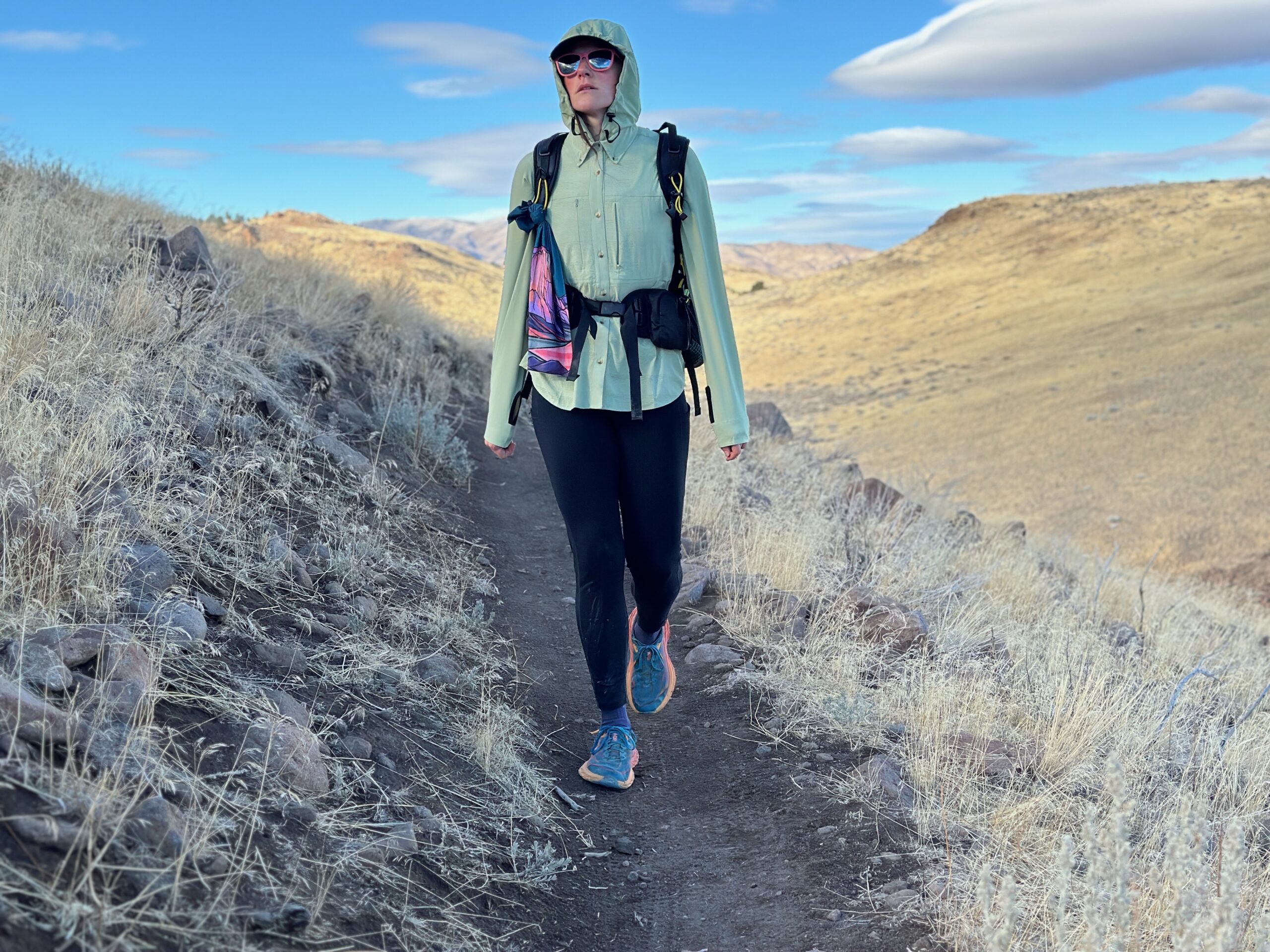 woman hiking in high desert with backpack on