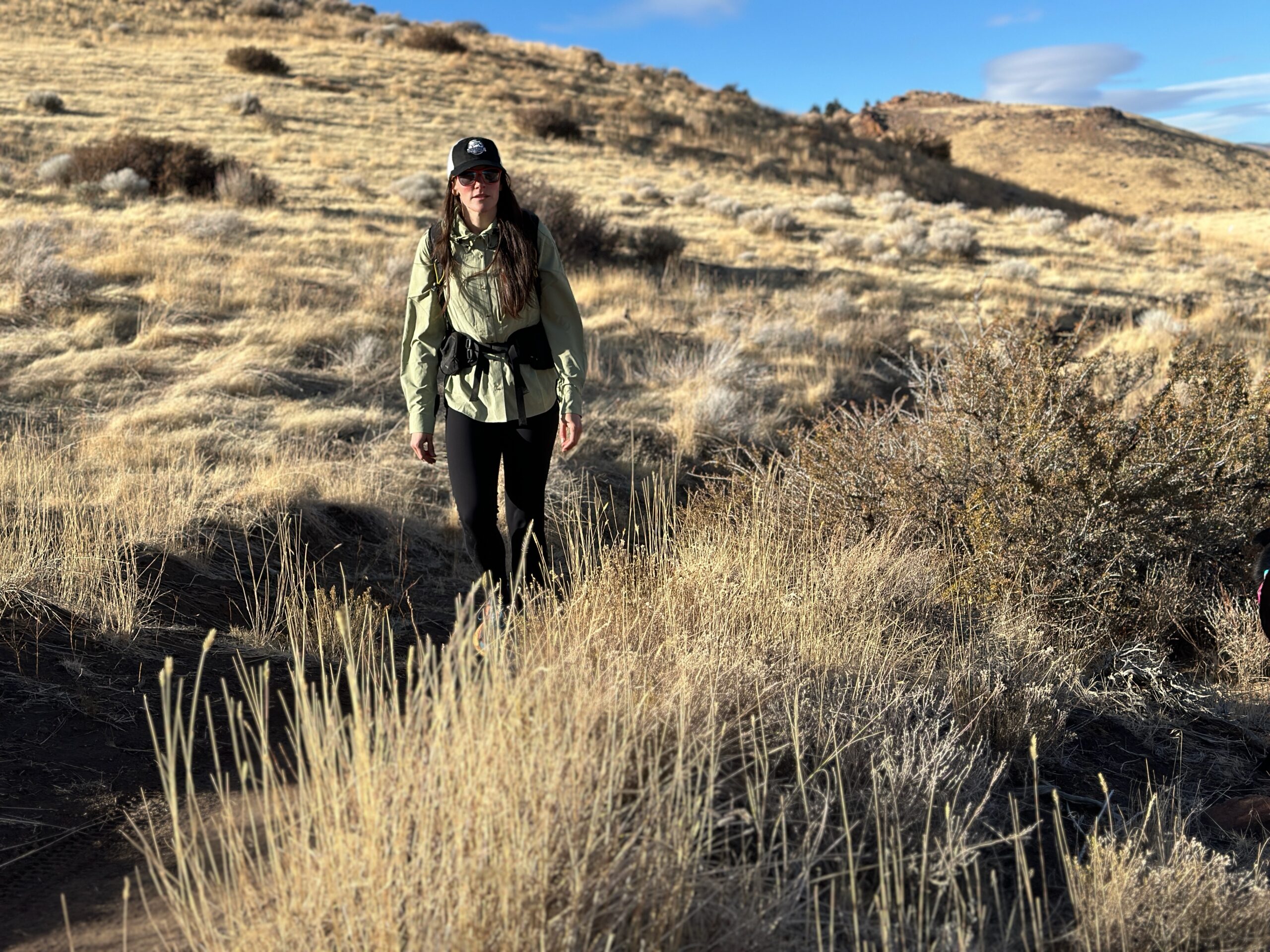 woman hiking in high desert with backpack on