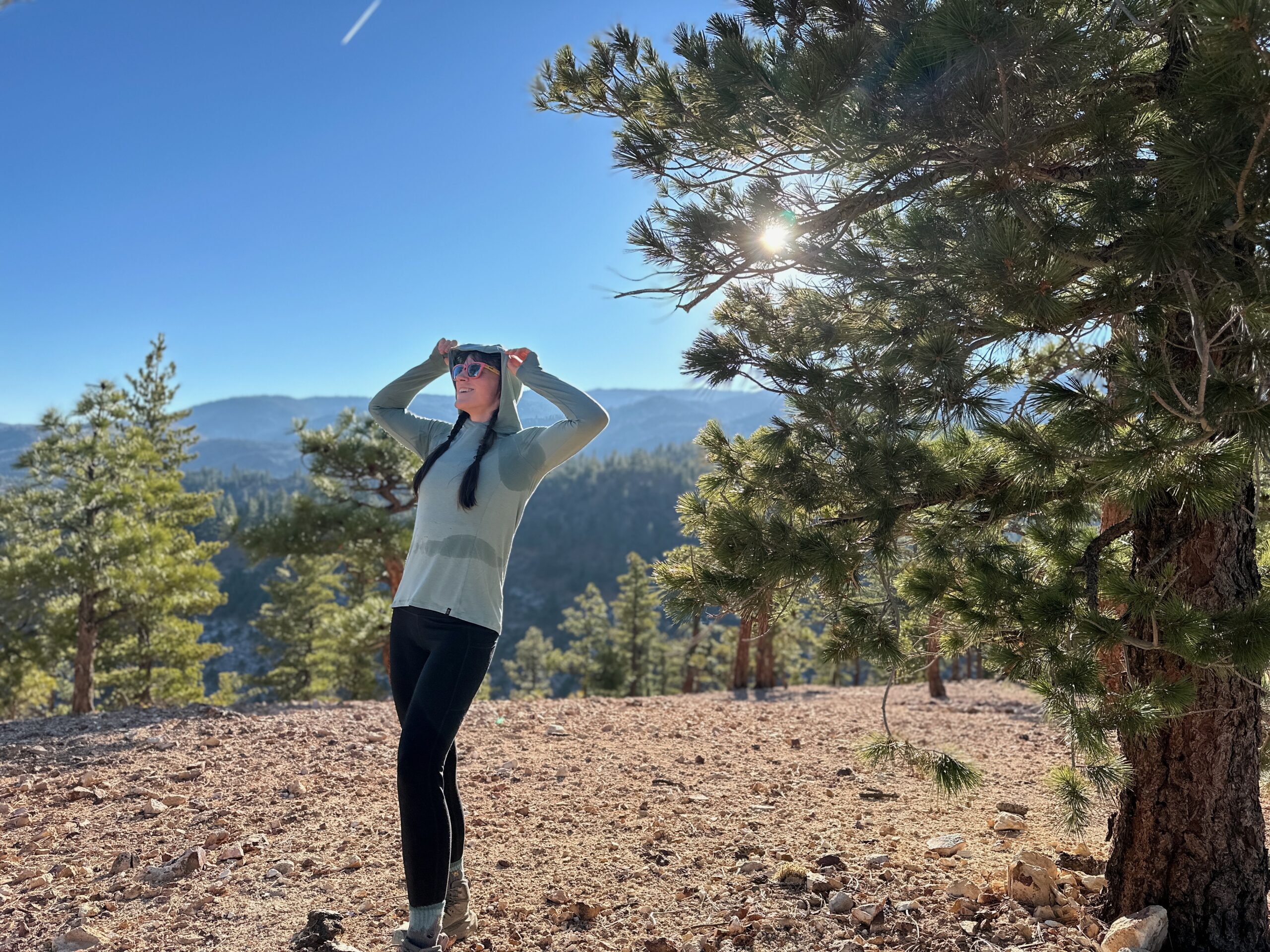 woman hiking with backpacking pack on in pine forest