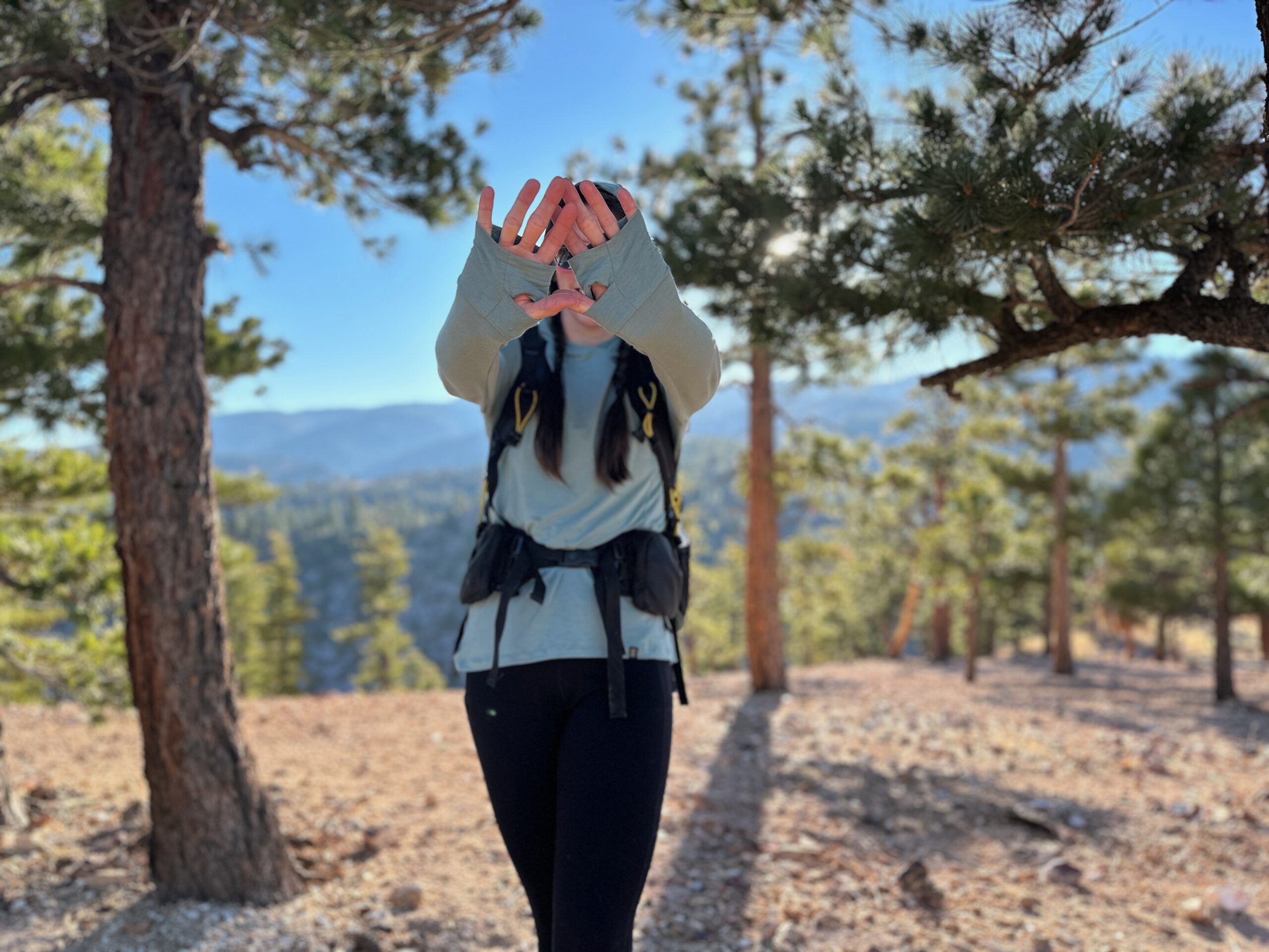 woman hiking with backpacking pack on in pine forest