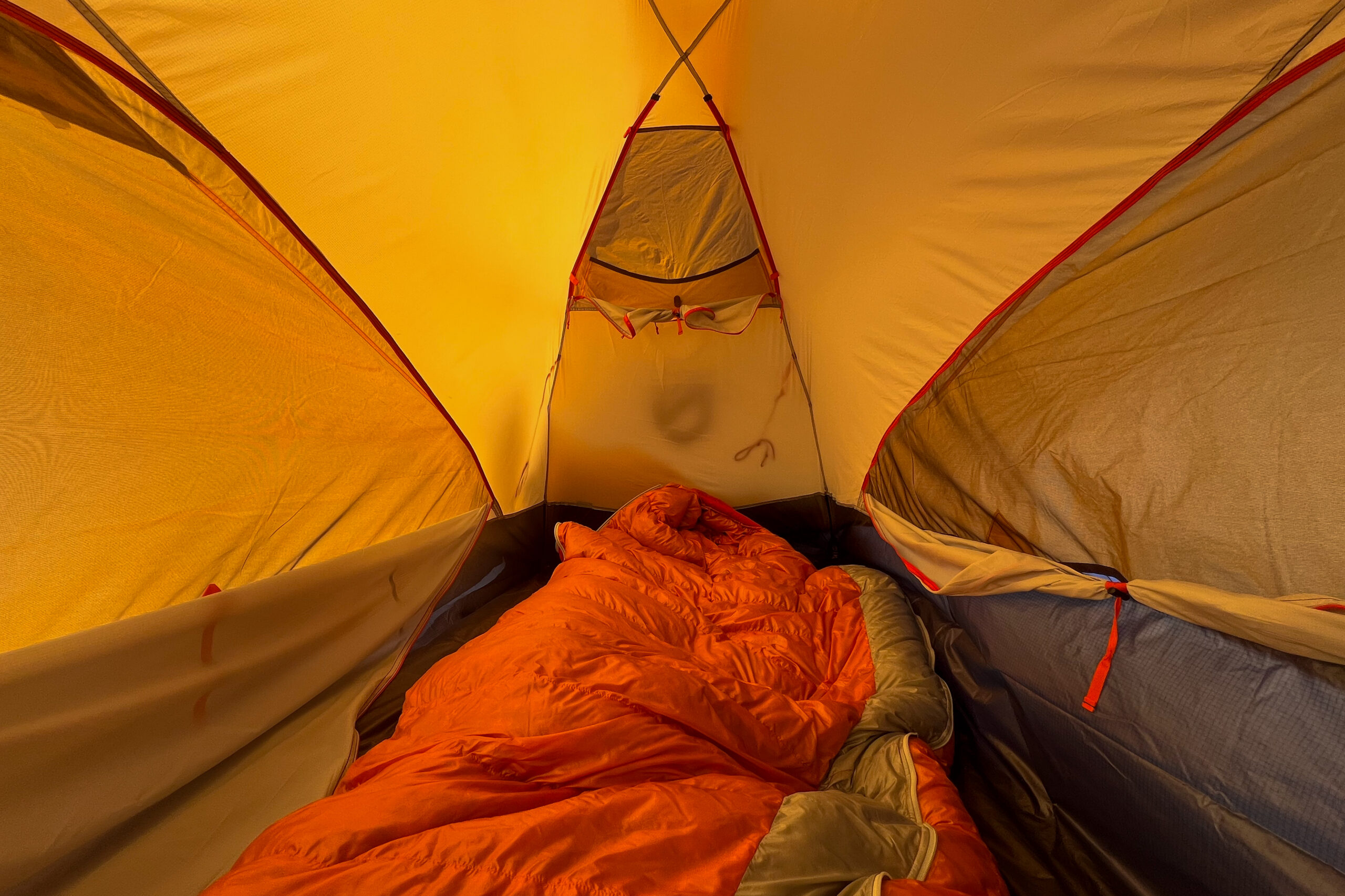 The interior of the Nemo Kunai 2 tent featuring two sleeping bags and mesh storage pockets on the walls.
