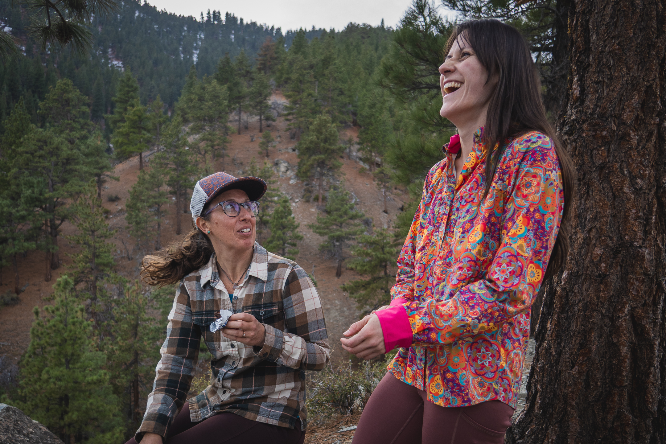 woman hiking with colorful shirt in pine forest