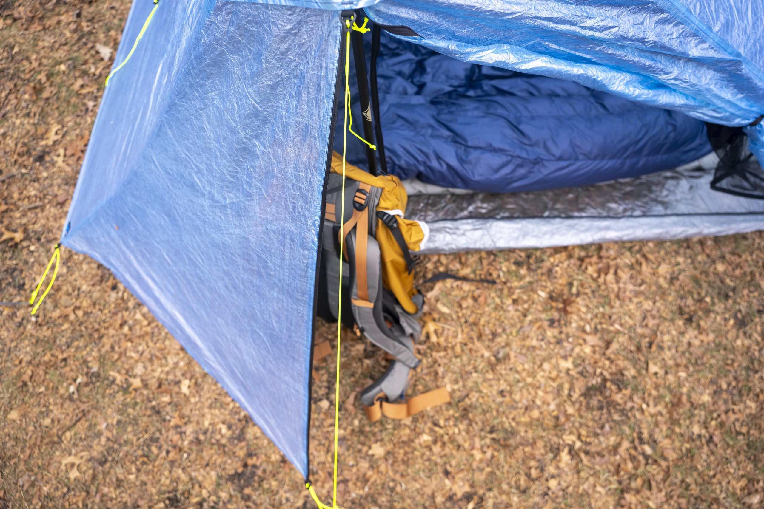 a backpack rests in a vestibule of a tent