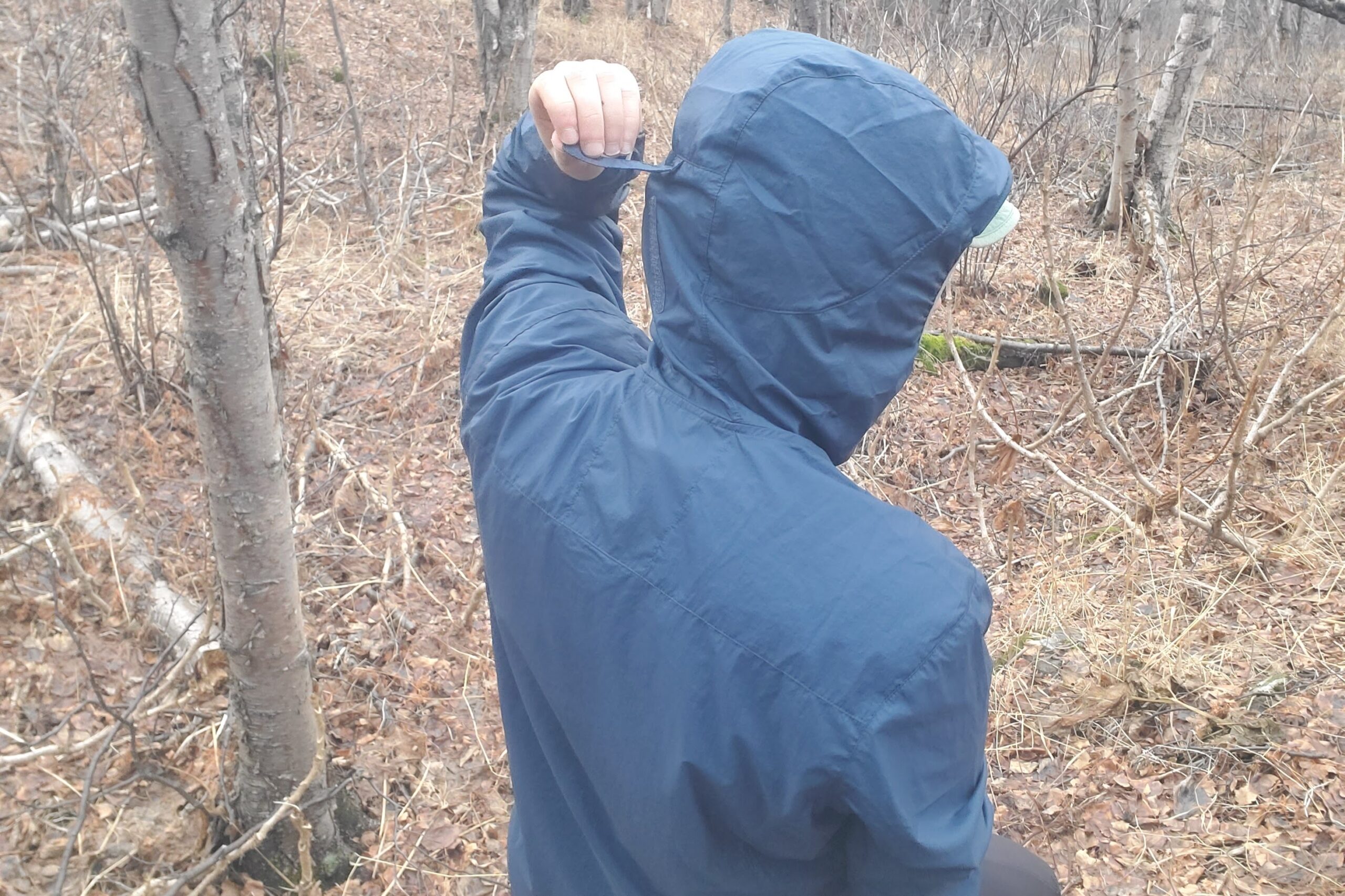 A man tightens the velcro on his hood.