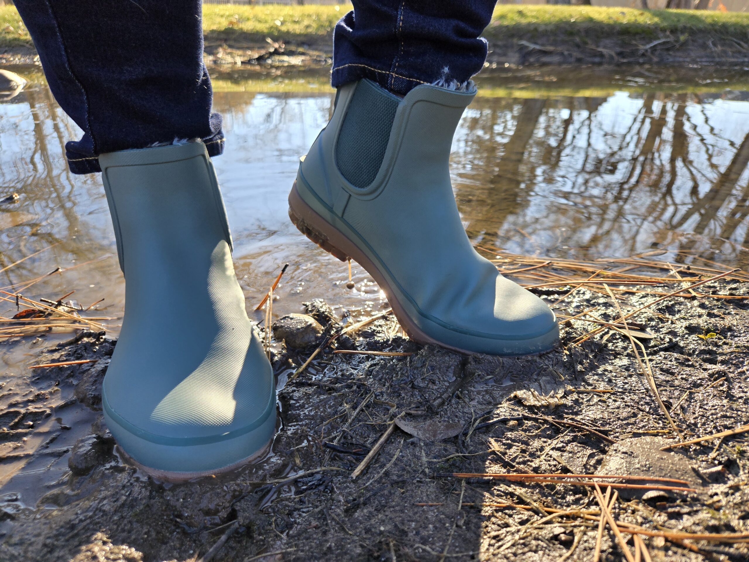a women wearing bogs amanda chelsea next to a pond