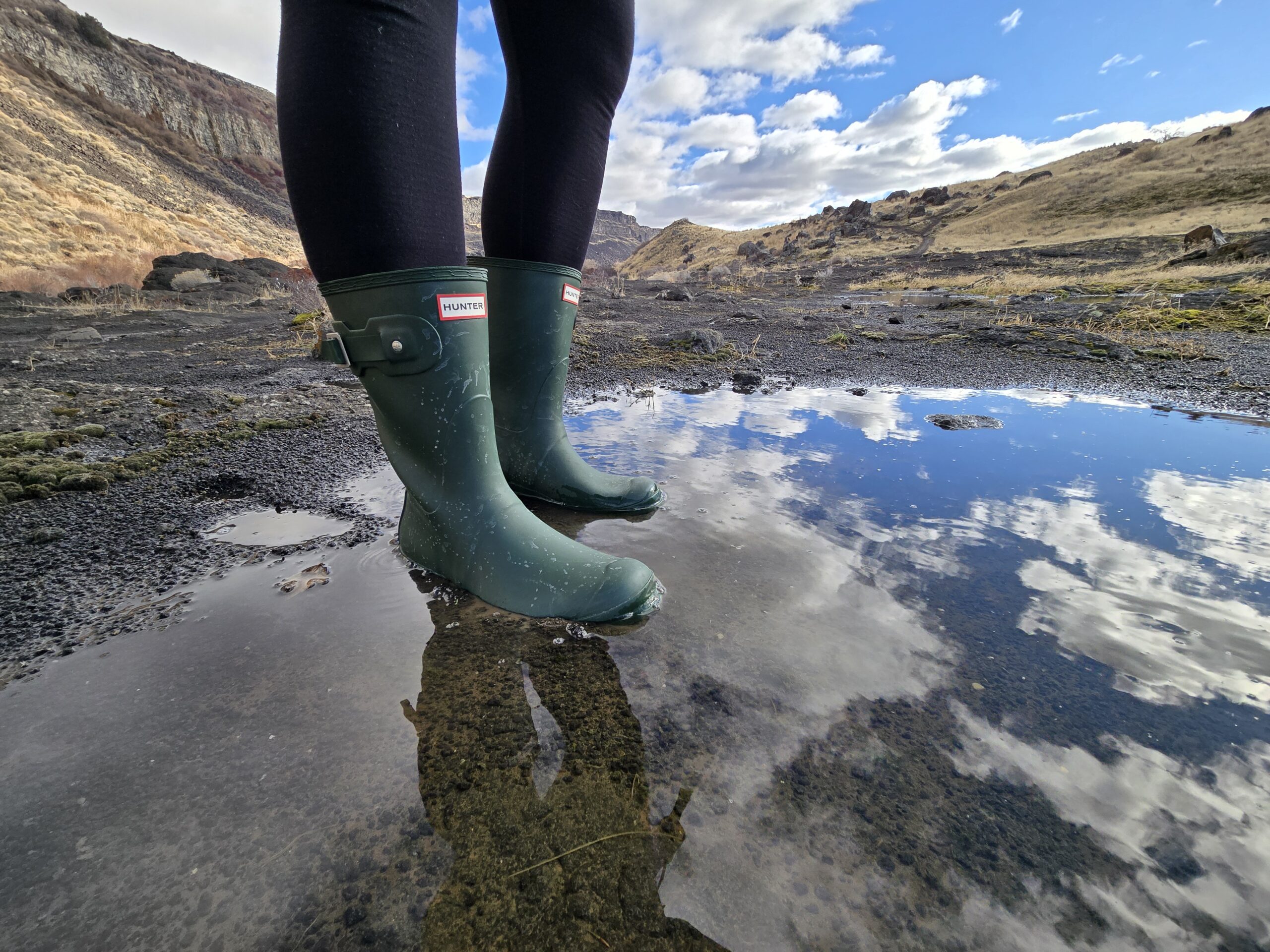 woman's legs wearing hunter original short boots