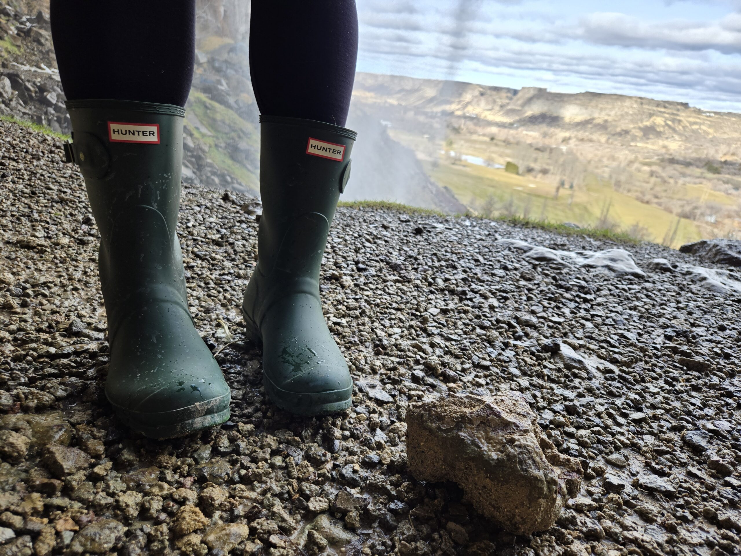women in hunter original short boots next to a river