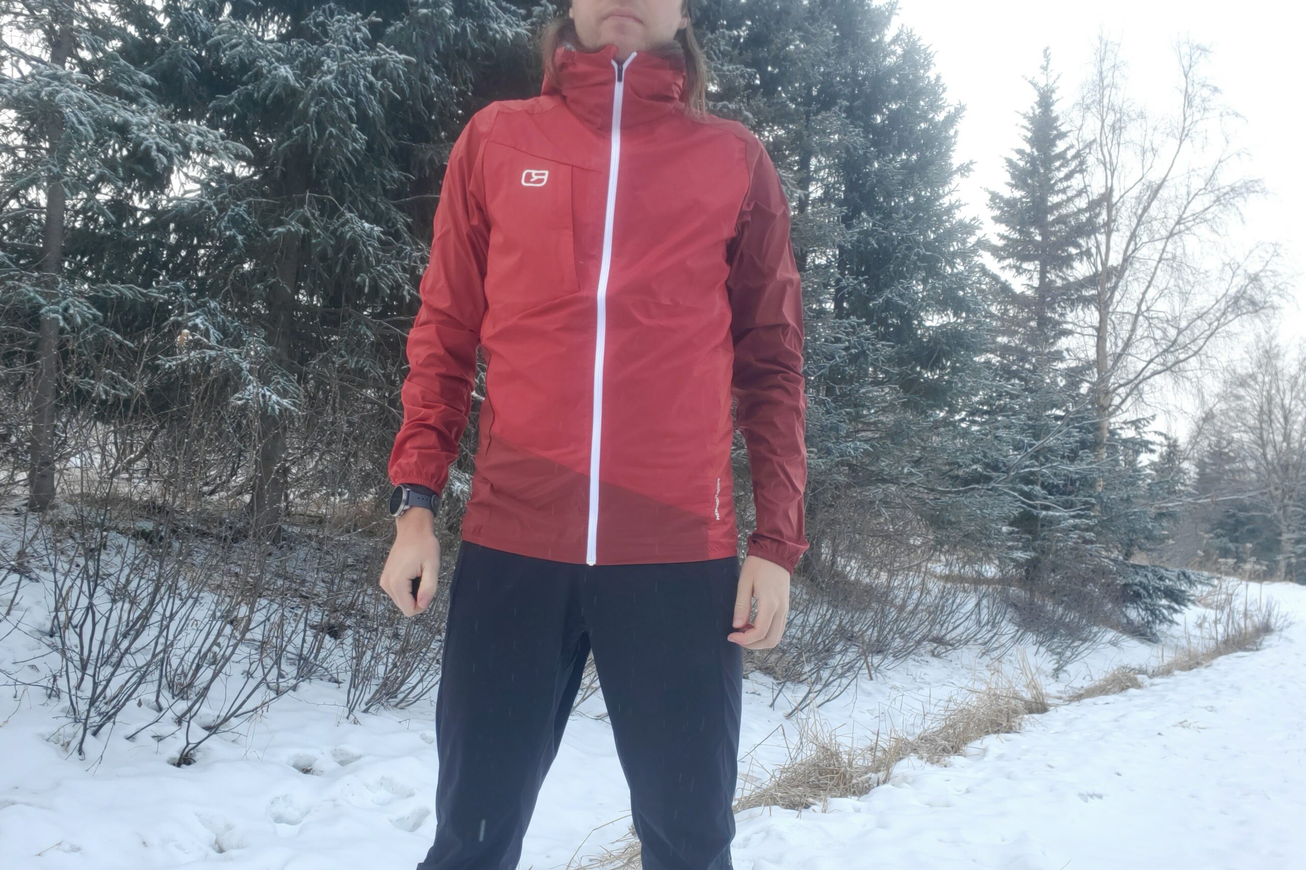 A closeup of the front of a red windbreaker.