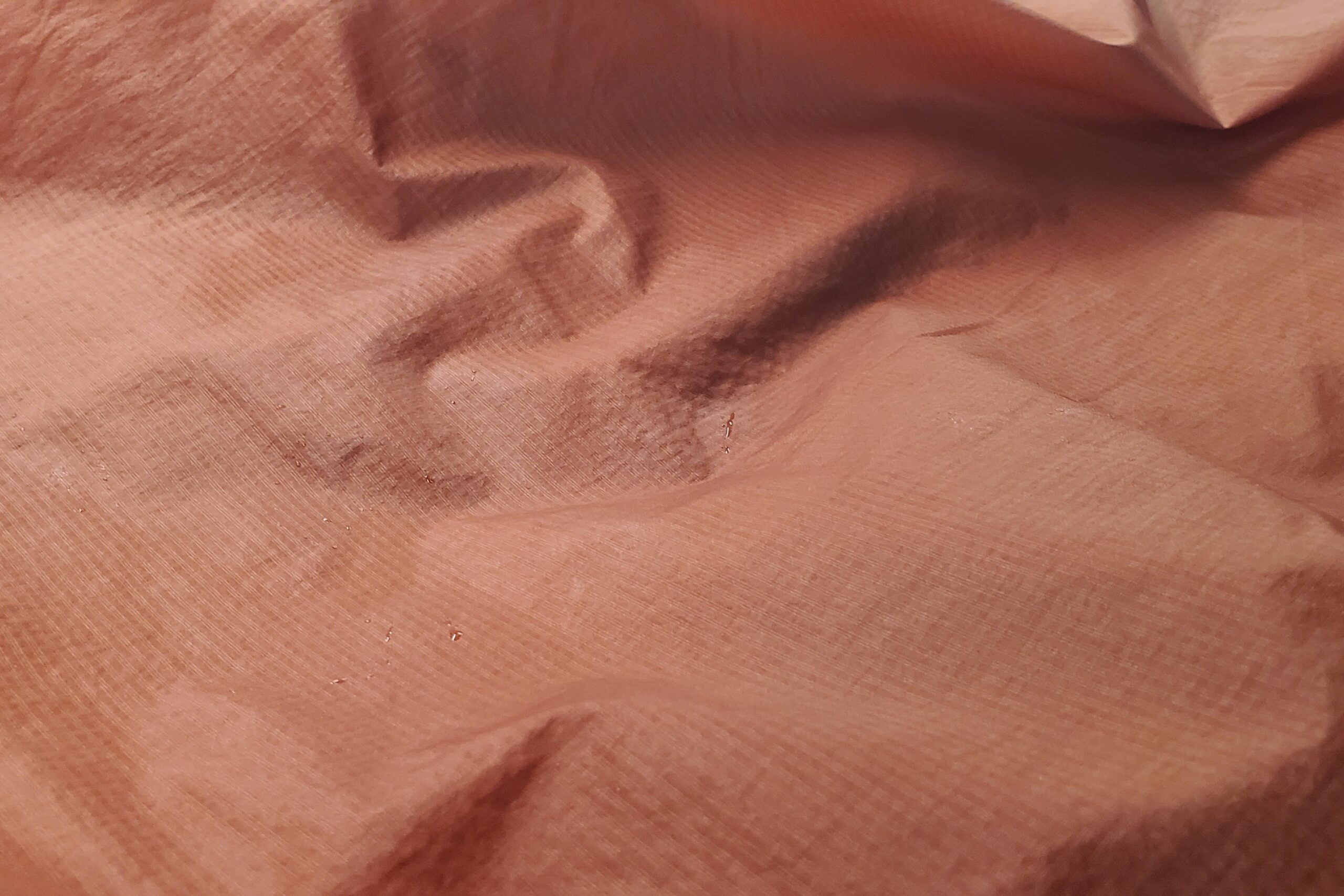 A closeup of sweat trapped on the underside of a windbreaker.