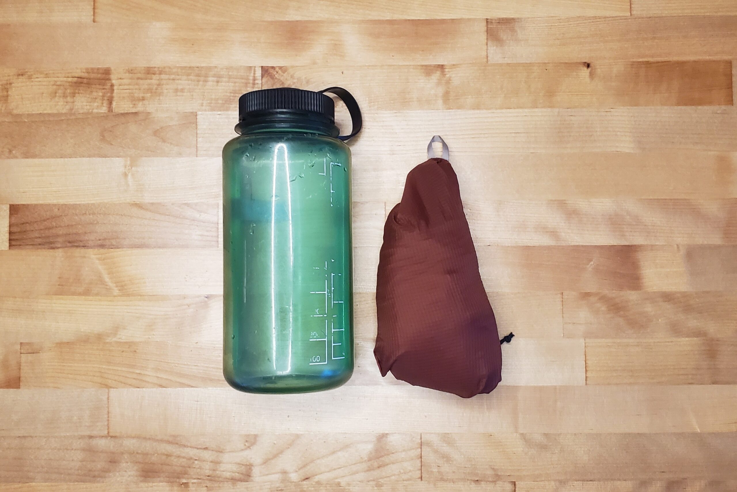 A bundled up windbreaker compared to a one liter bottle.