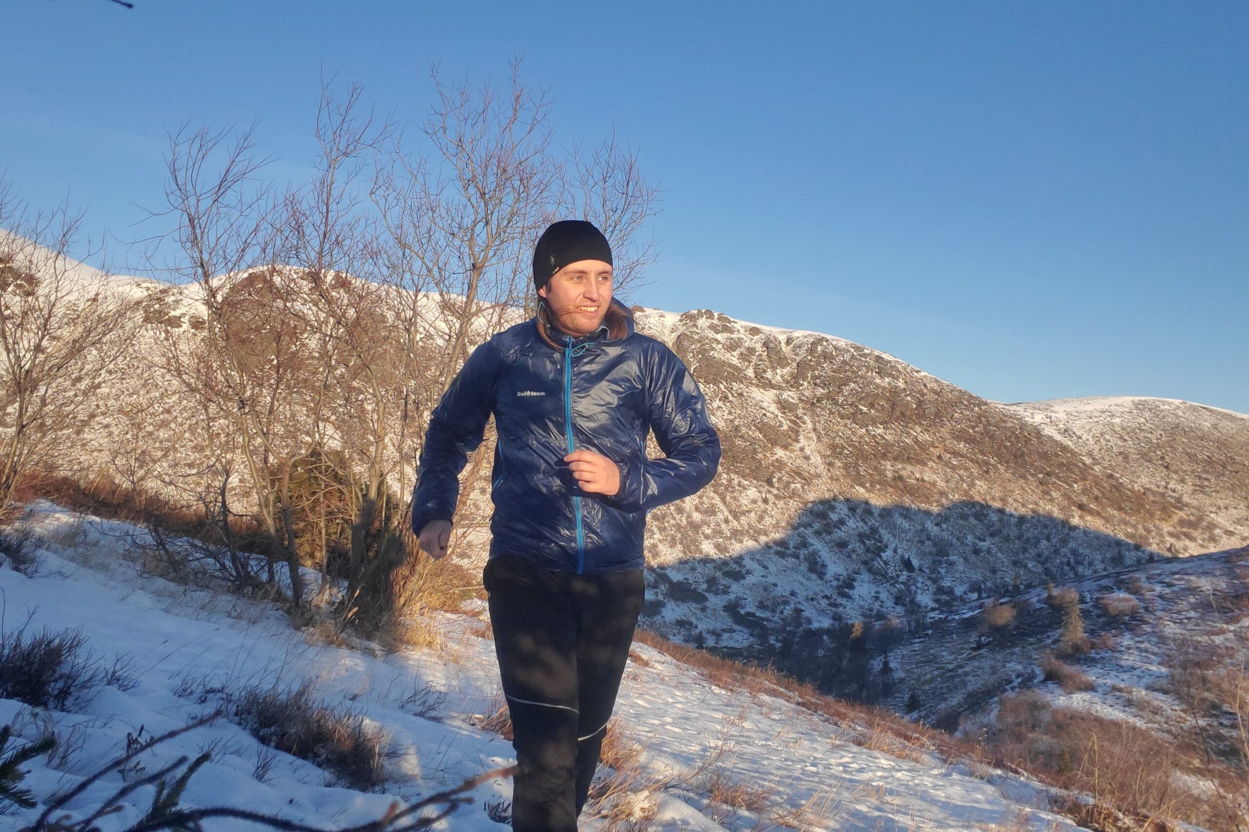 A man runs towards the camera on a ridgeline.