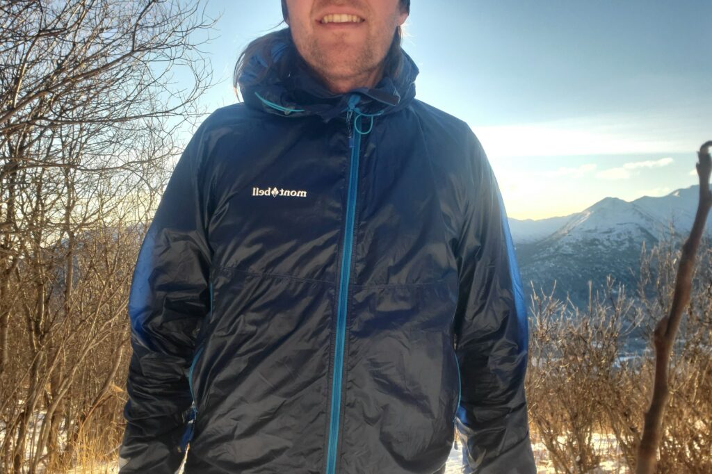 A closeup of the front of a windbreaker backlit by the sun.