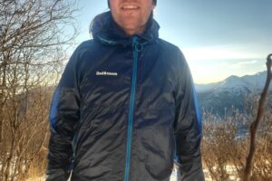A closeup of the front of a windbreaker backlit by the sun.
