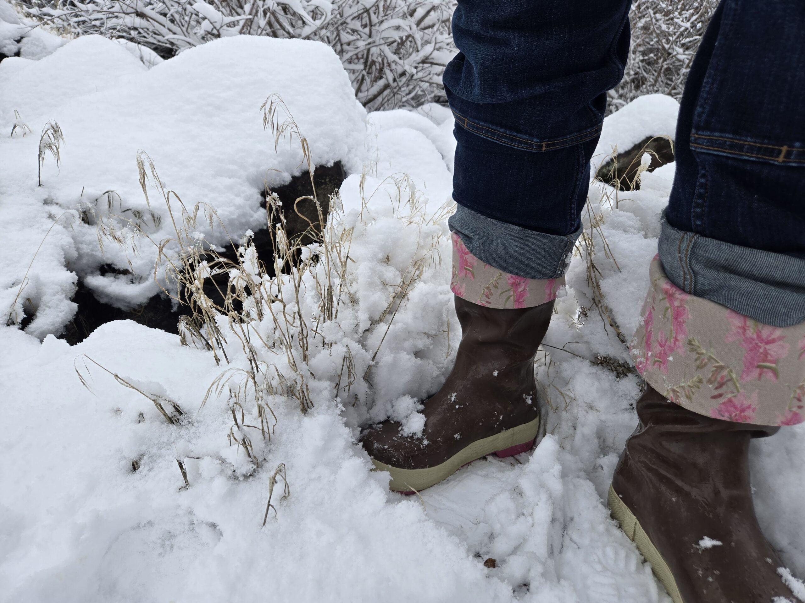 woman walking in some fresh snow in xtratuf work boots