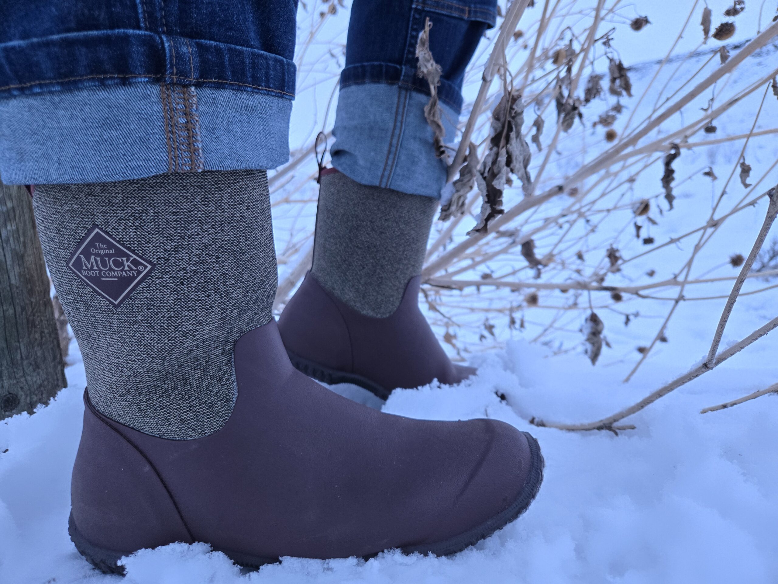 woman wearing muckster boots in the snow