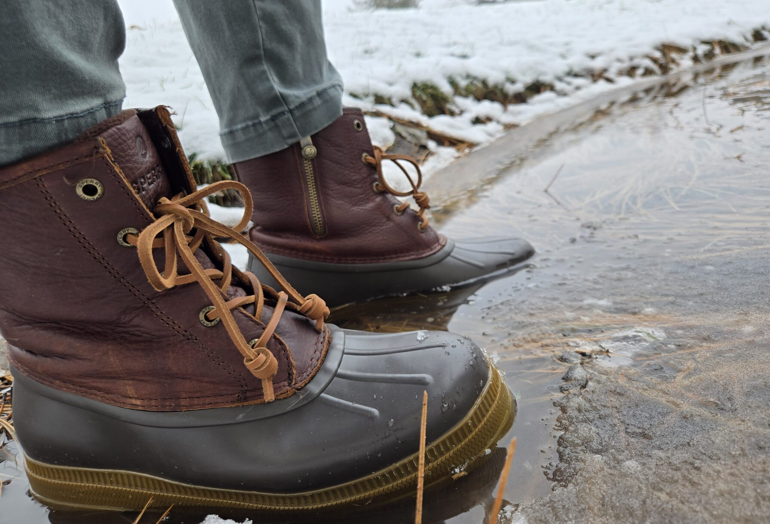 a woman wearing the sperry saltwater 2.0  in a pond