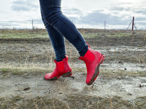 woman on a farm walking in mud in ankle rain boots by asgard