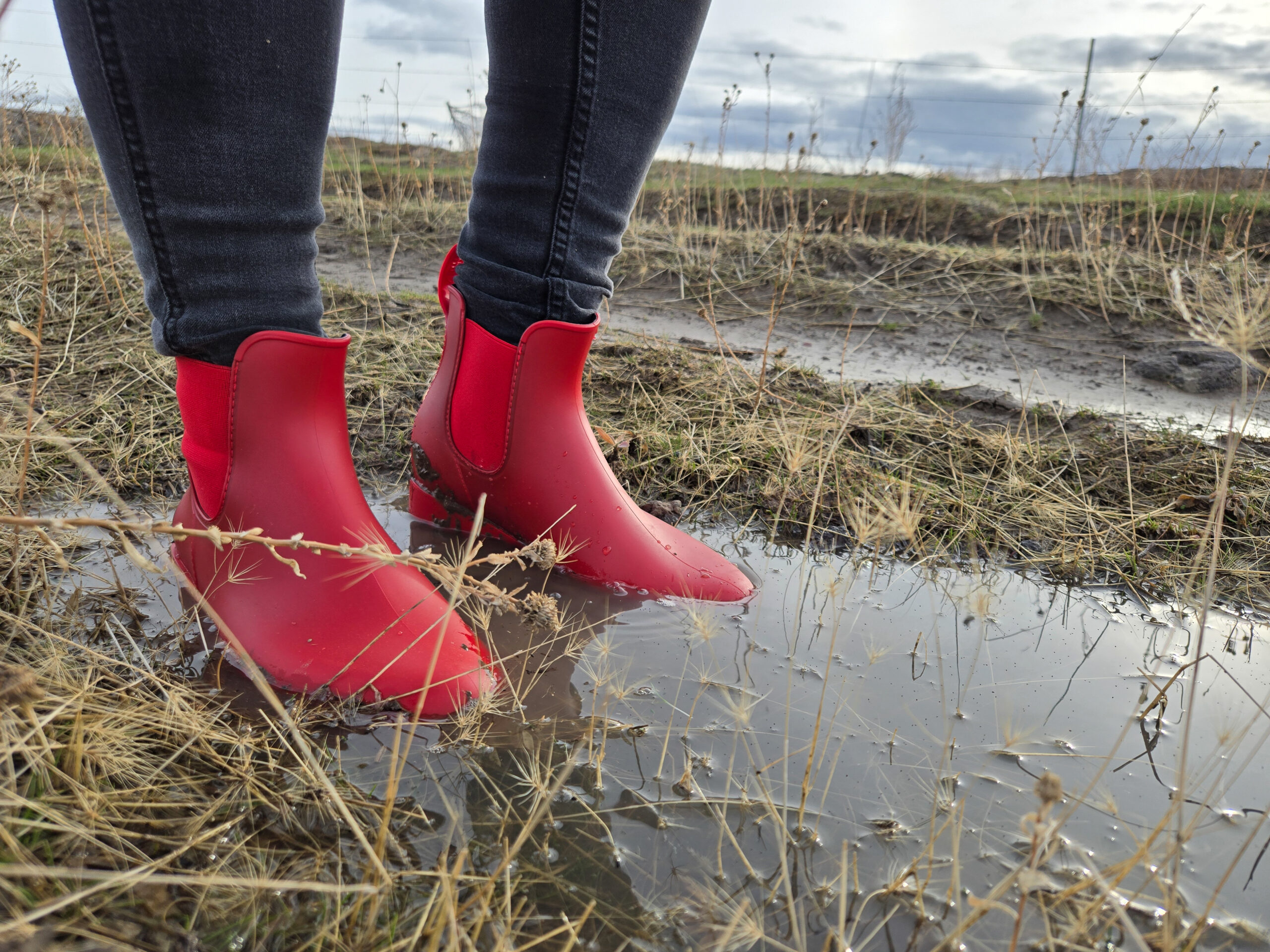 woman standing in puddles while wearing the asgard chelsea