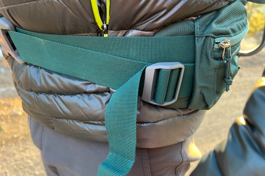 A close-up of the padded and adjustable waist belt on the Deuter Kid Comfort backpack carrier, emphasizing its ergonomic design.