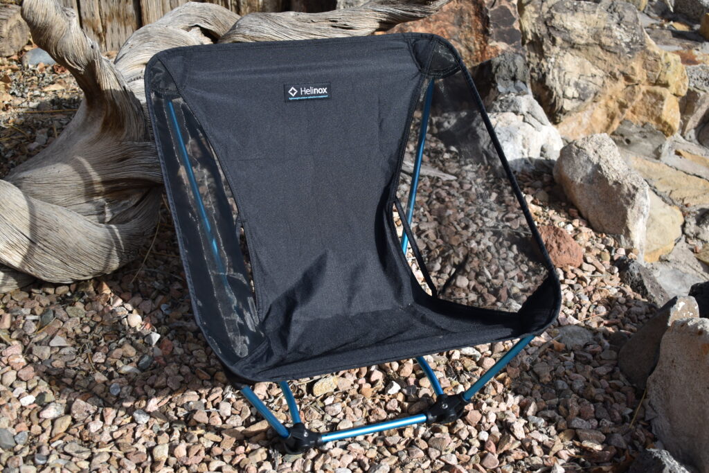 Close up of Helinox Ground Chair with rocks and driftwood in the background