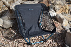Close up of Helinox Ground Chair with rocks and driftwood in the background