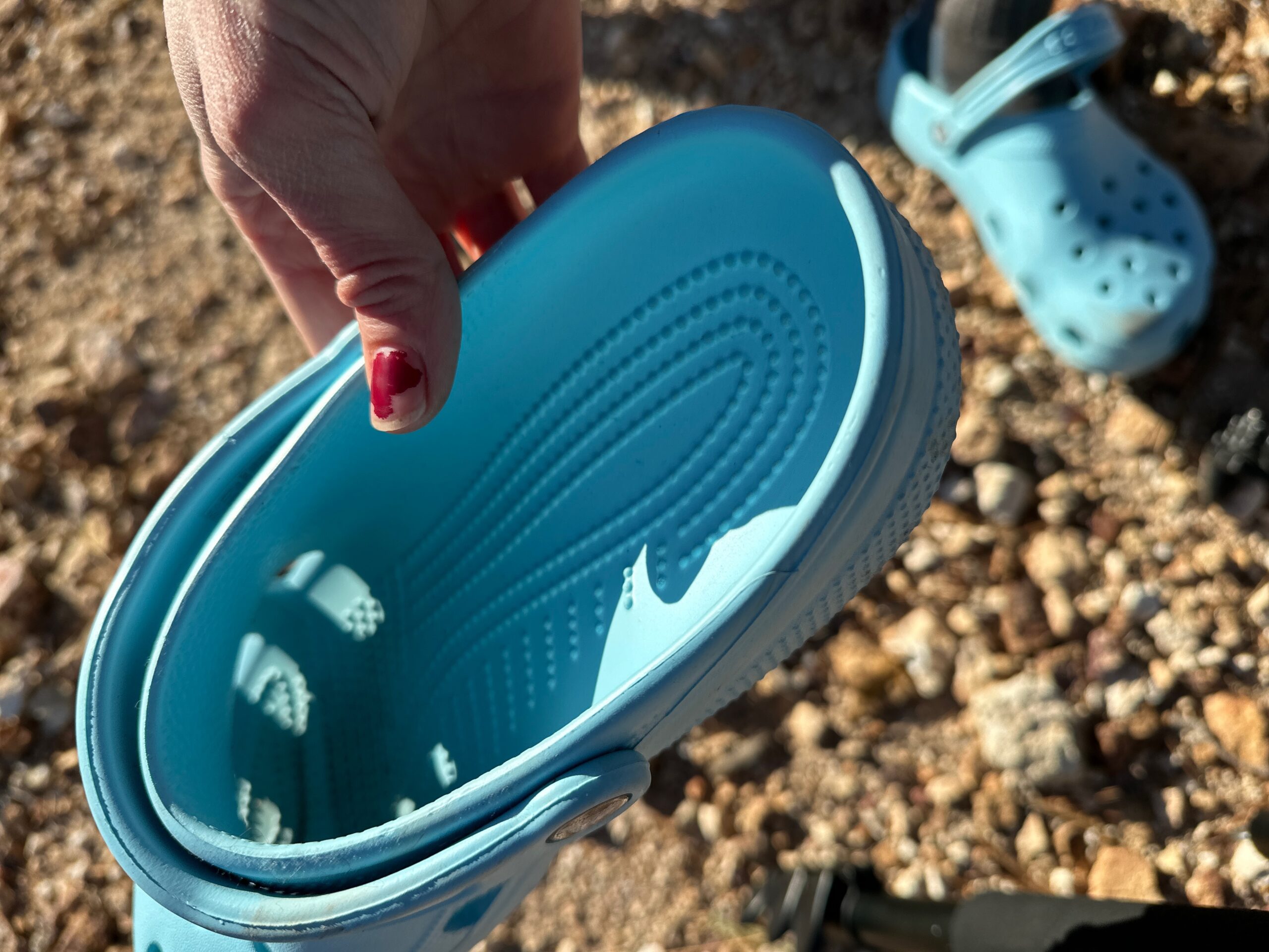 the Crocs Classic Clogs in blue traveling around a camp site in the high desert showing off its versatility and fit