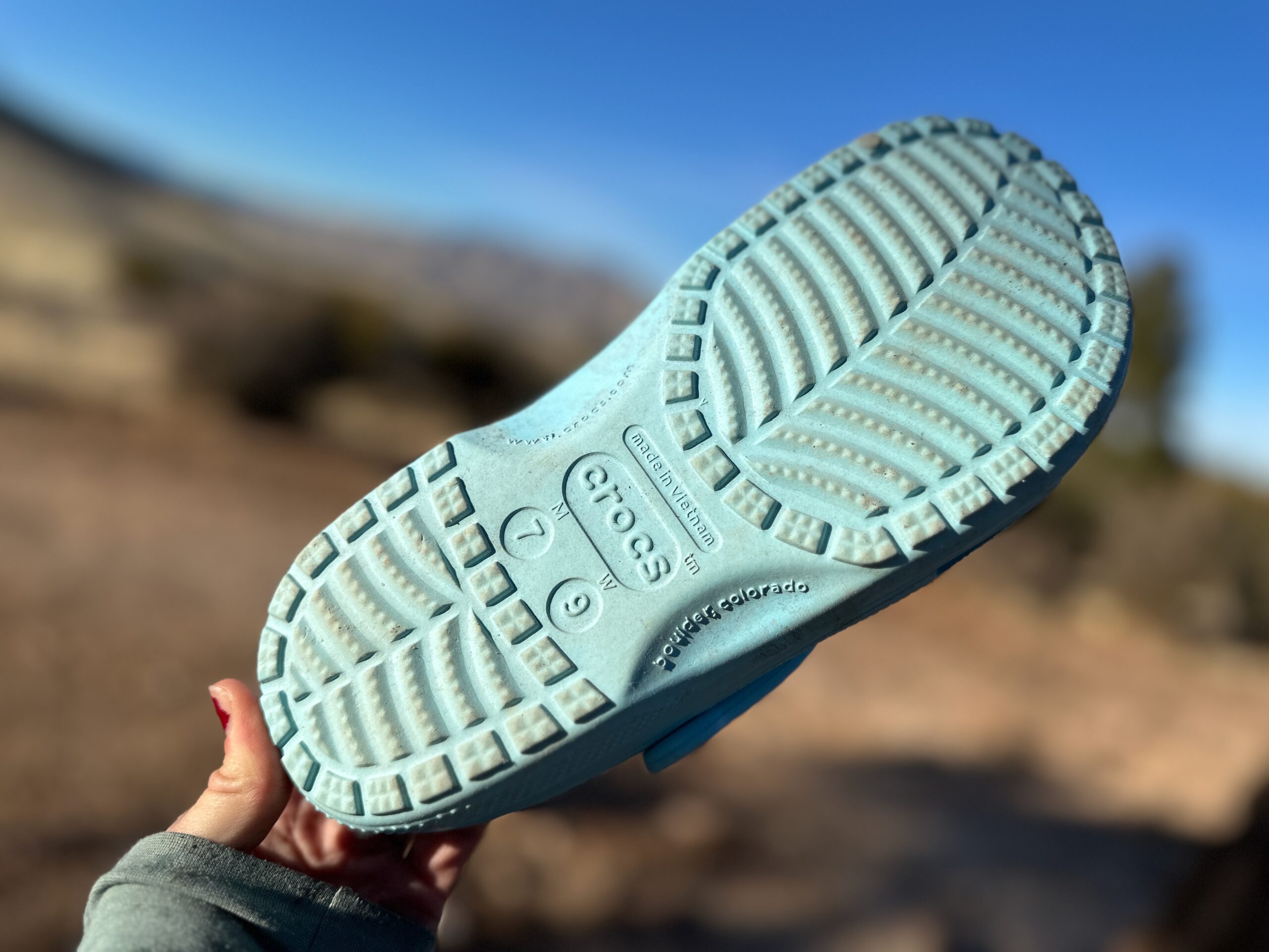 the Crocs Classic Clogs in blue traveling around a camp site in the high desert showing off its versatility and fit