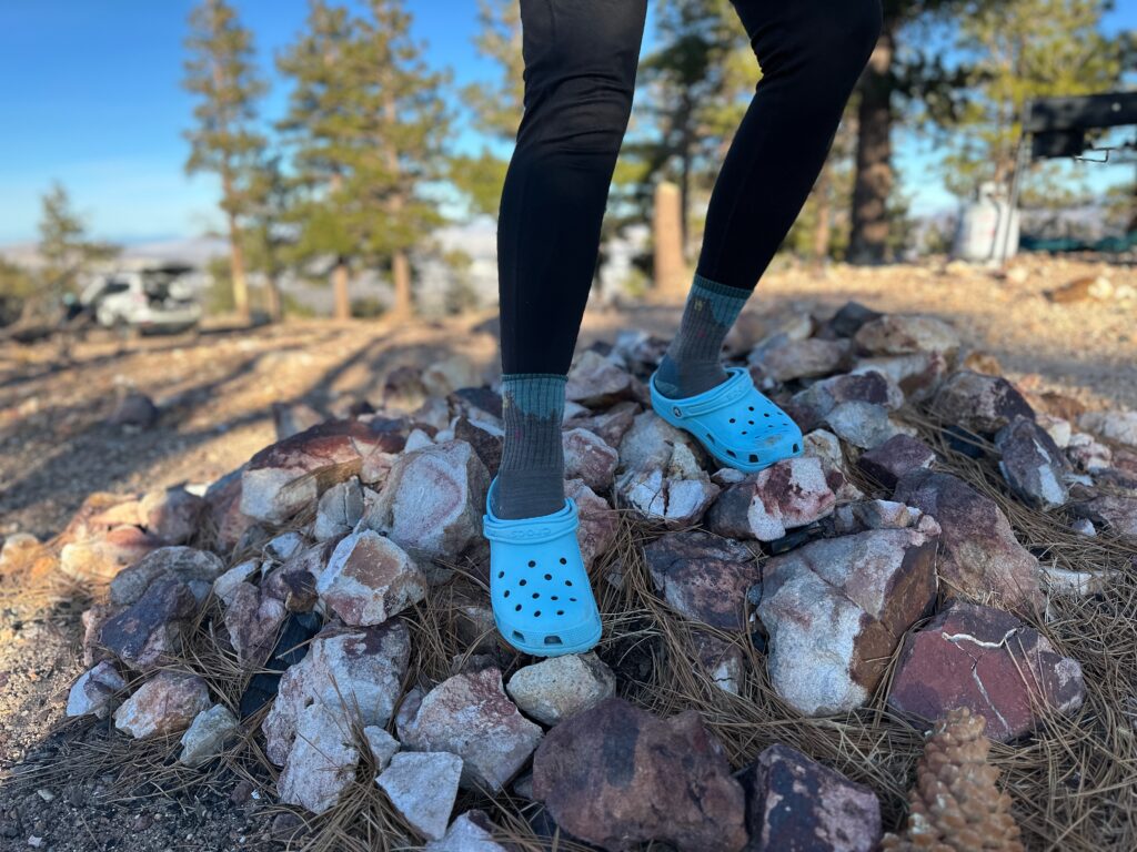 the Crocs Classic Clogs in blue traveling around a camp site in the high desert showing off its versatility and fit