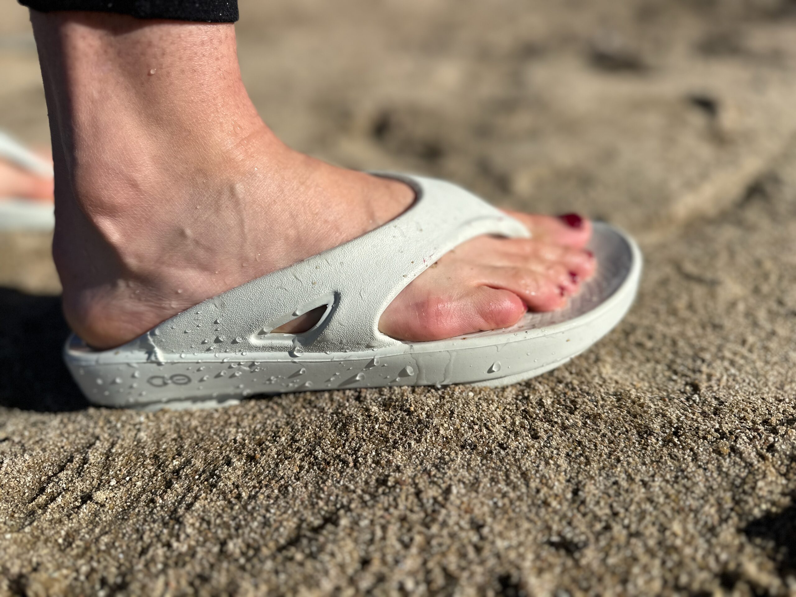 a woman wearing the OOfos OOriginals to show off the fit
