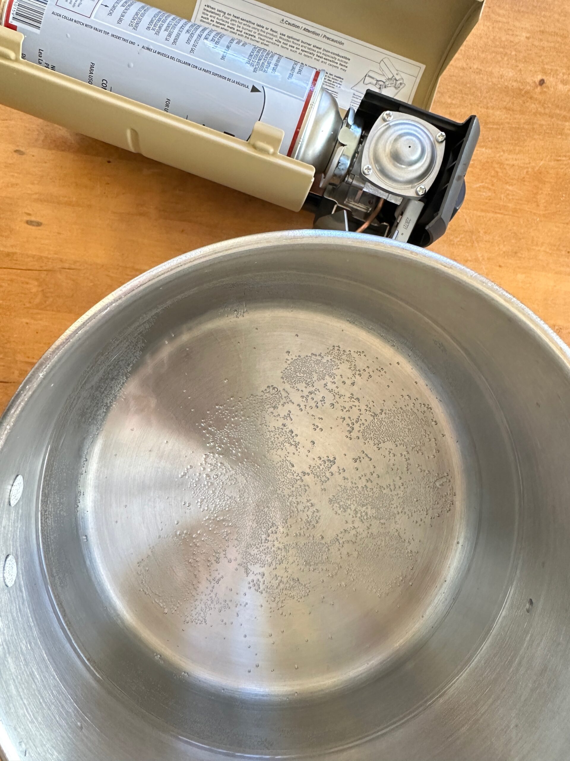 A close up of a pot of water beginning to boil