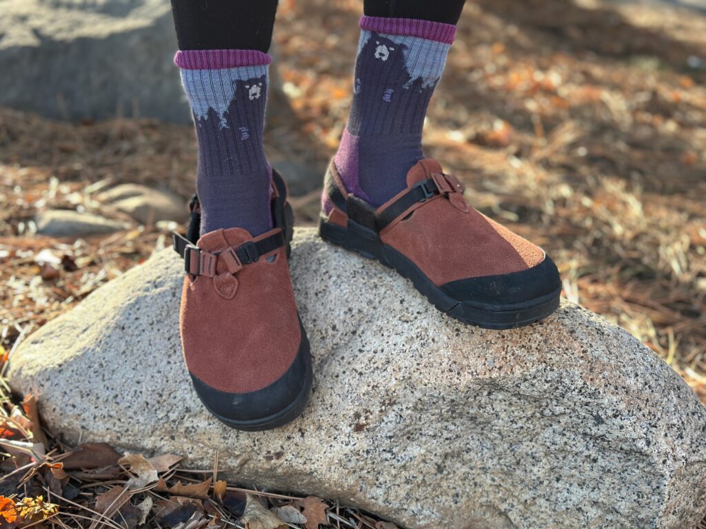 a woman shoes off the traction of the Bedrock Mountain Clog