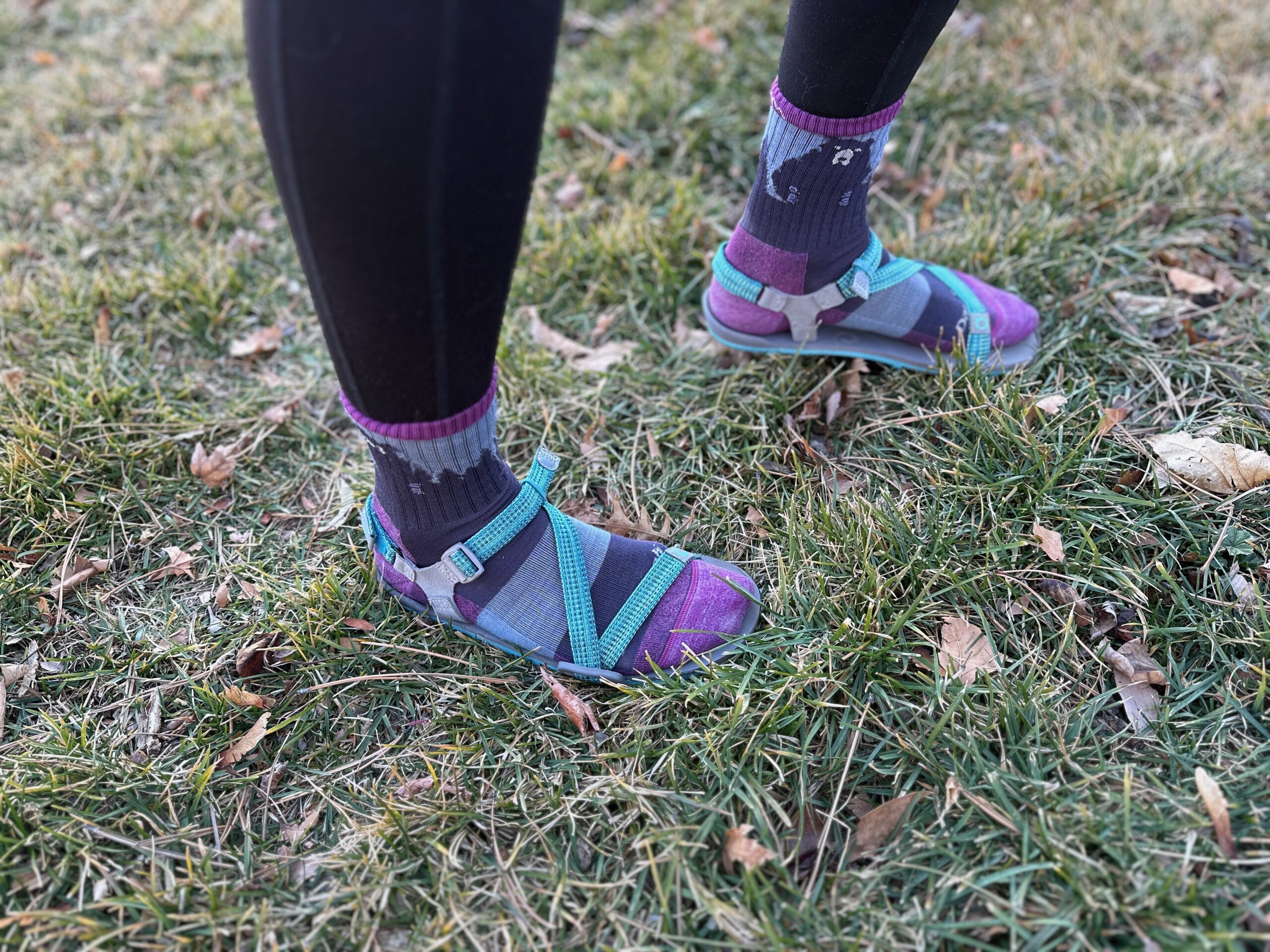 a woman wears the Xero Shoes Z-Trail EV on grass to show off the fit of the shoe