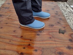 A ground level view of someone wearing the light blue Huk Rogue Wave boot.