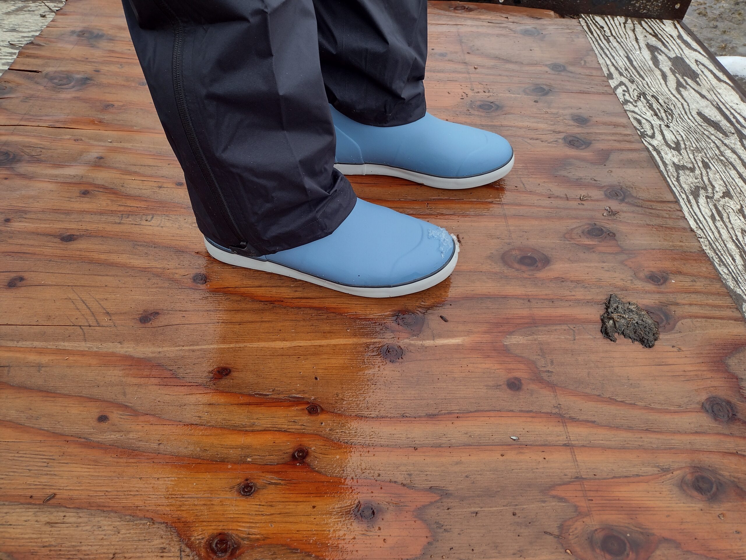 A ground level view of someone wearing the light blue Huk Rogue Wave boot.