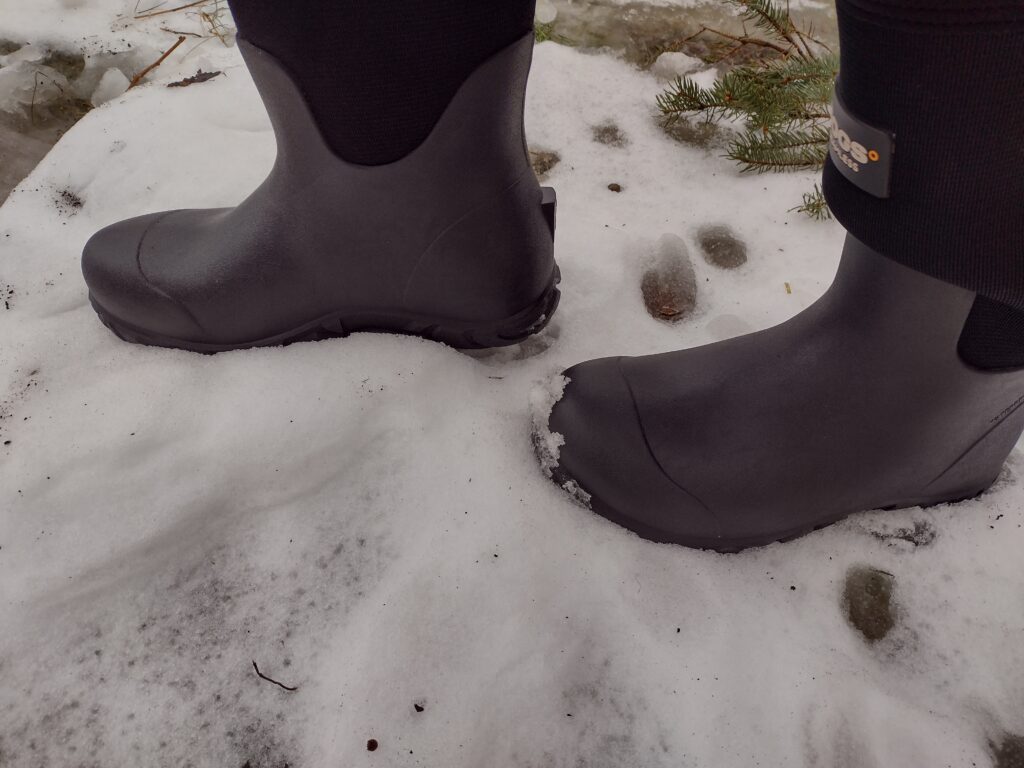 Ground level view of someone wearing the black Bogs Workman in the snow.