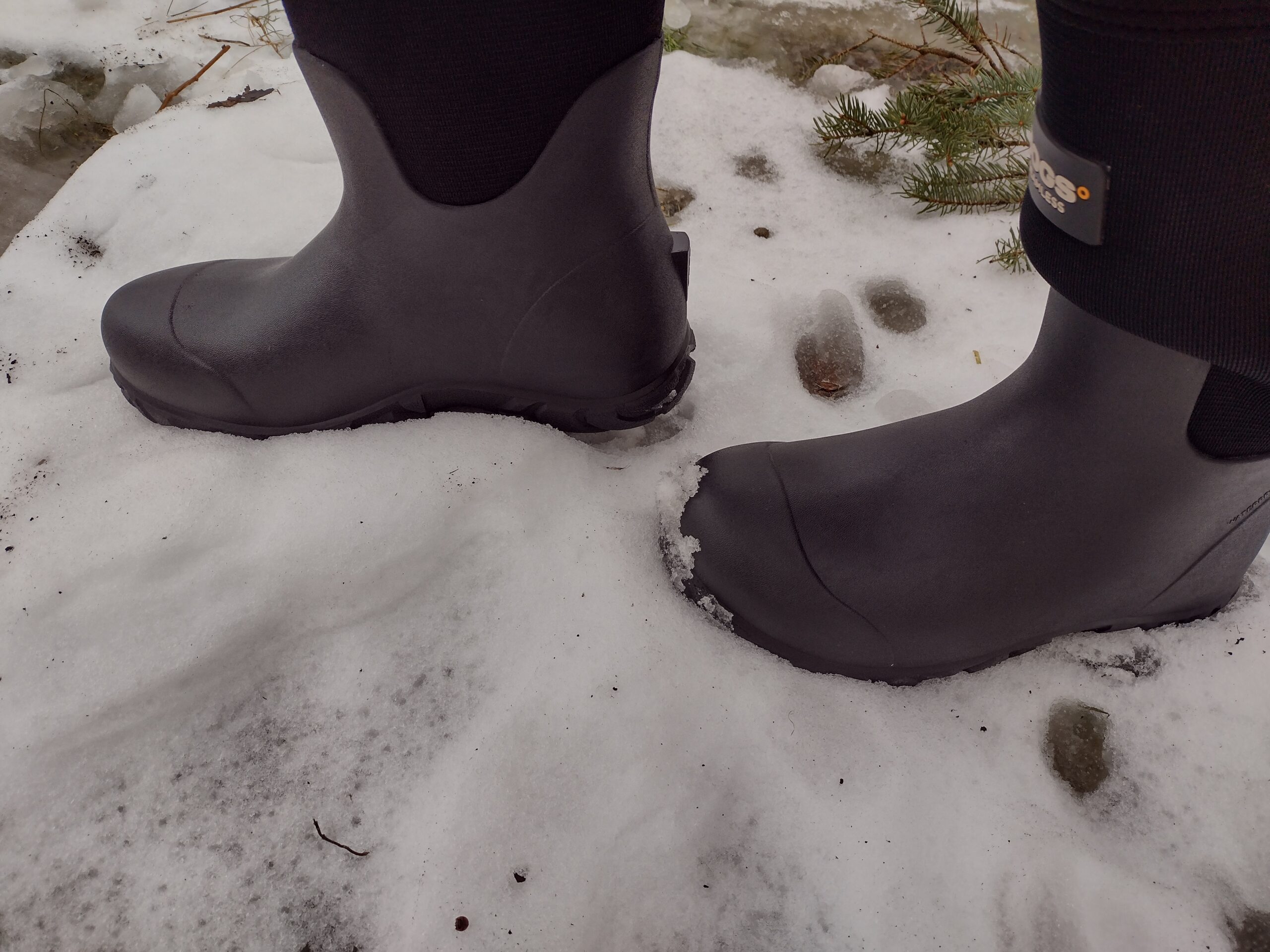 Ground level view of someone wearing the black Bogs Workman in the snow.