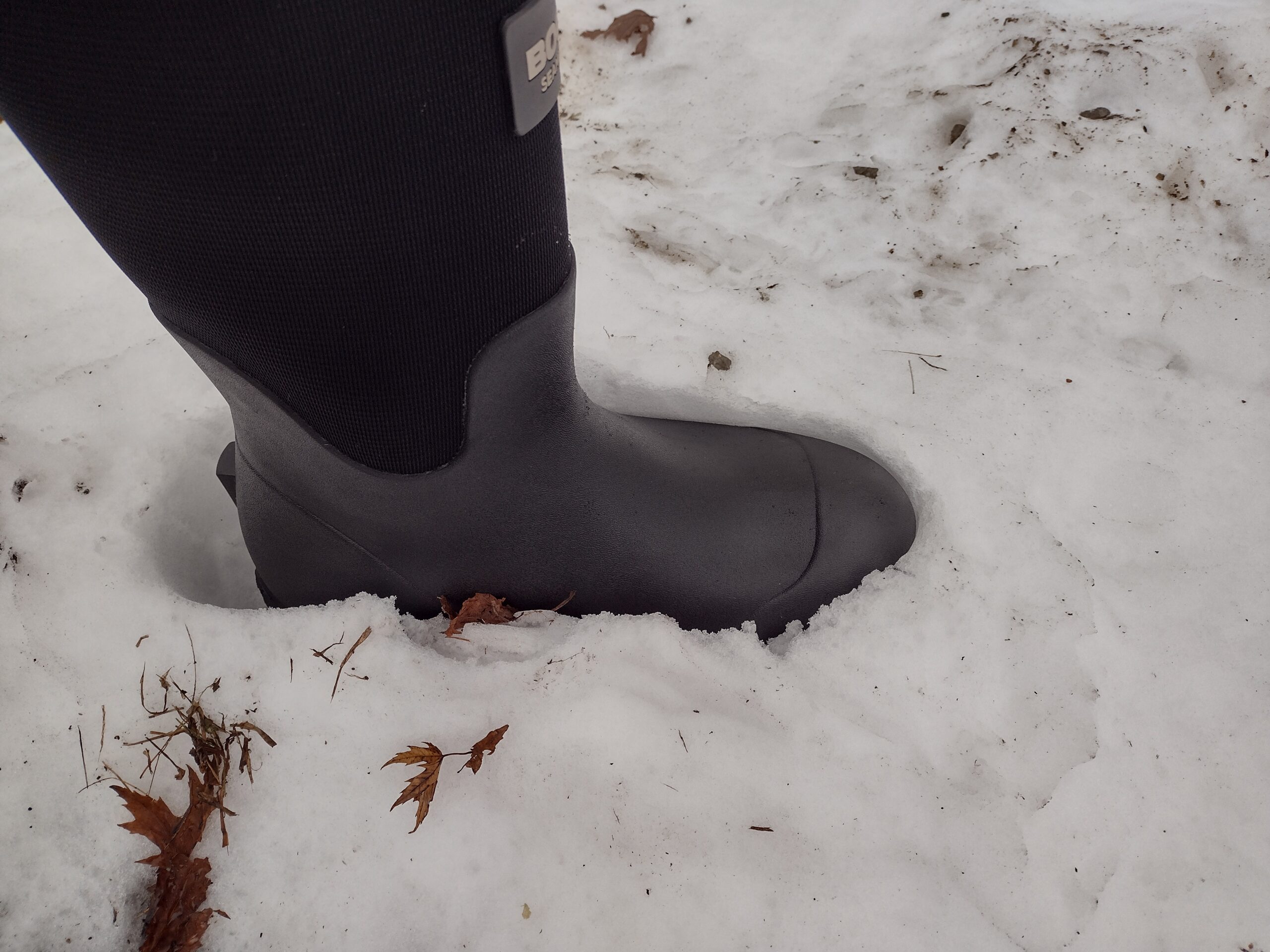 Ground level view of someone wearing the black Bogs Workman in snow.