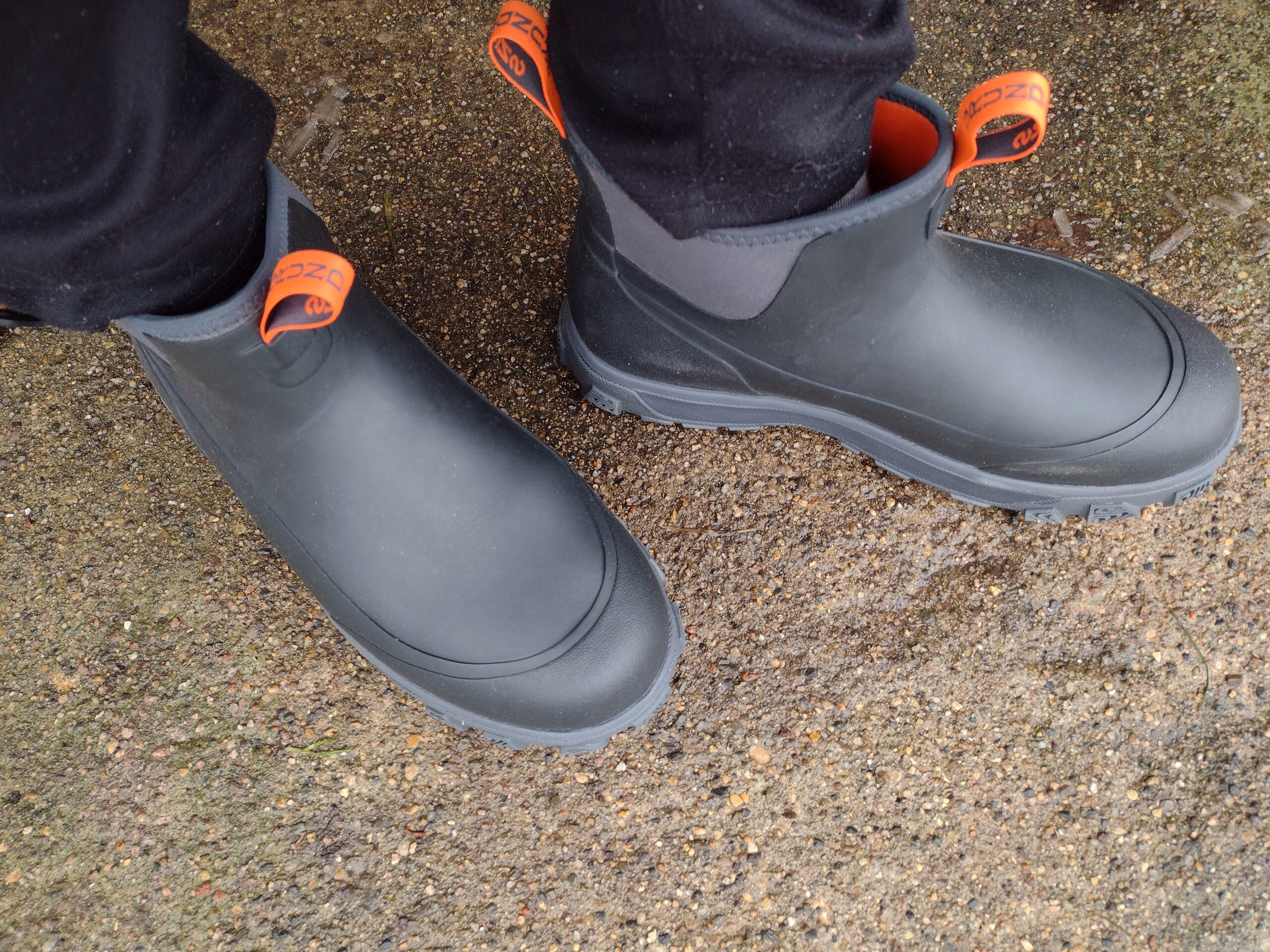 Ground level view of someone wearing the black Grundens Deviation Ankle Boot.