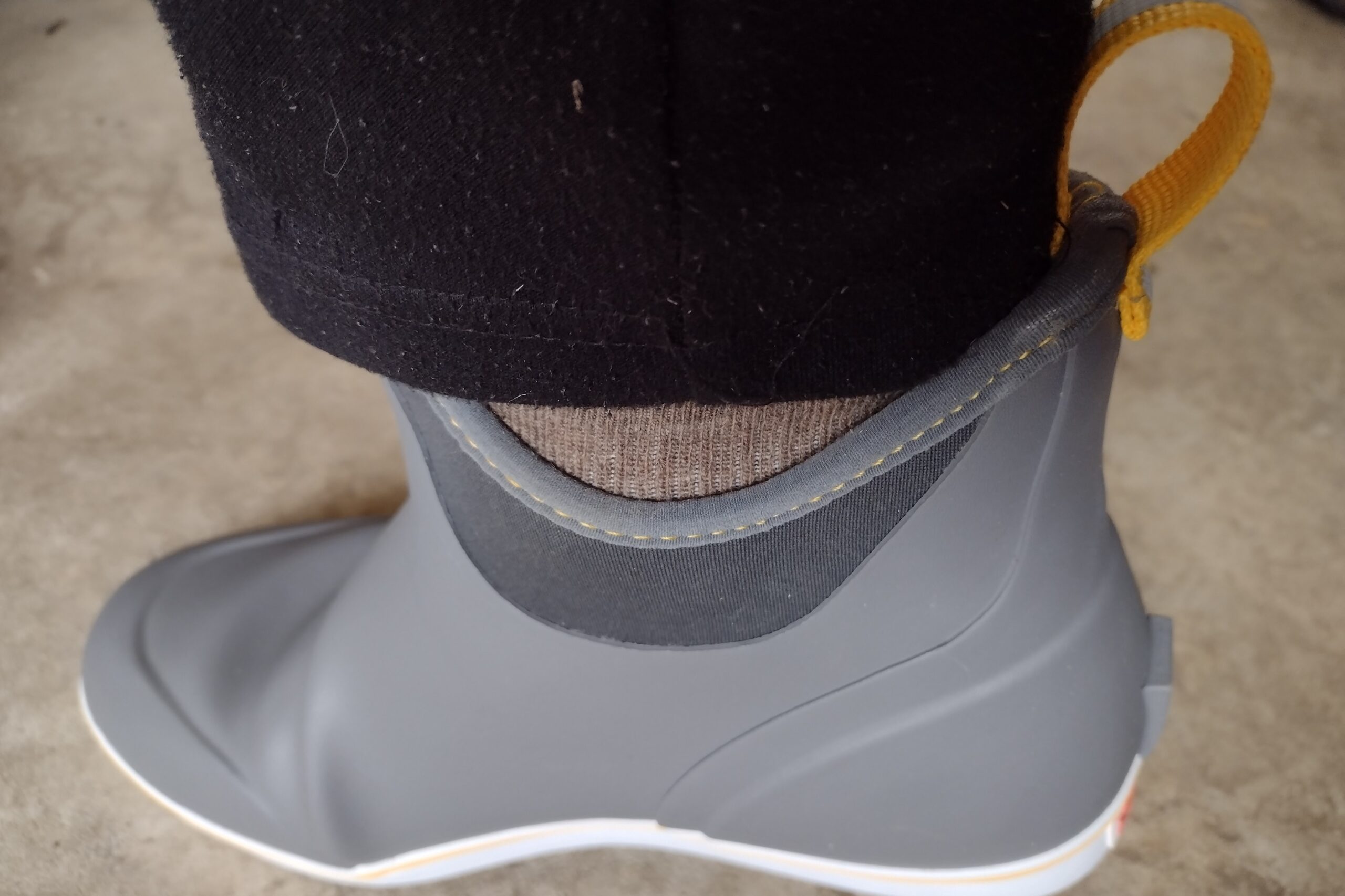 Ground level view of someone wearing the gray XTRATUF Ankle Deck Boot.