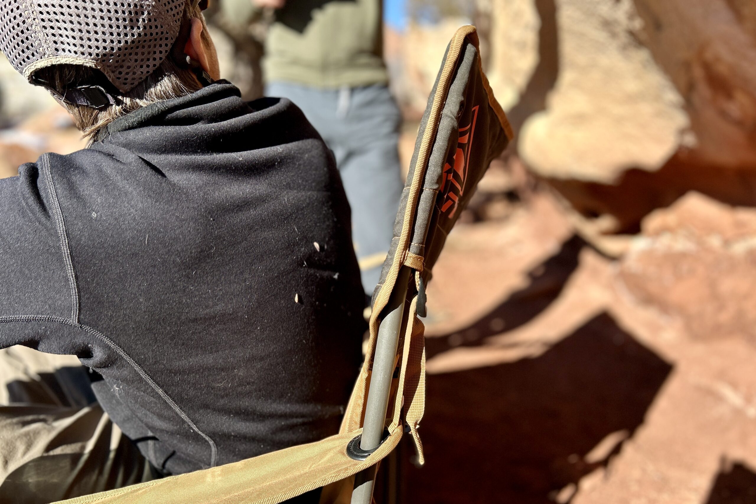 Close up of the back of a camping chair from the side.