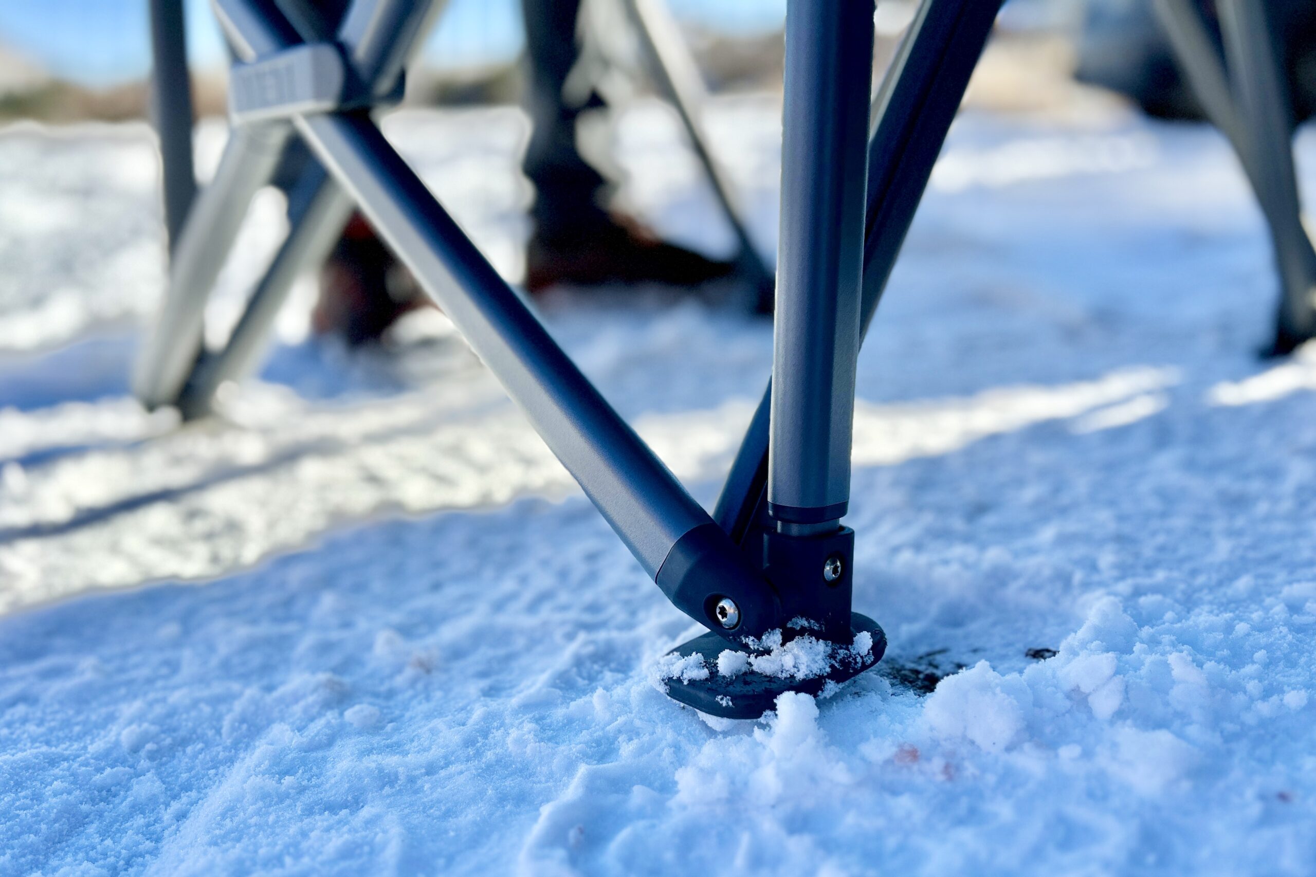 Close up of the feet and legs of a camping chair.