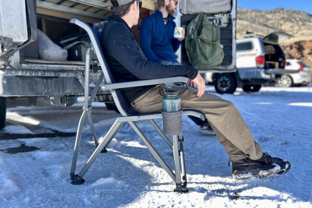Side profile of a man sitting in a camping chair.