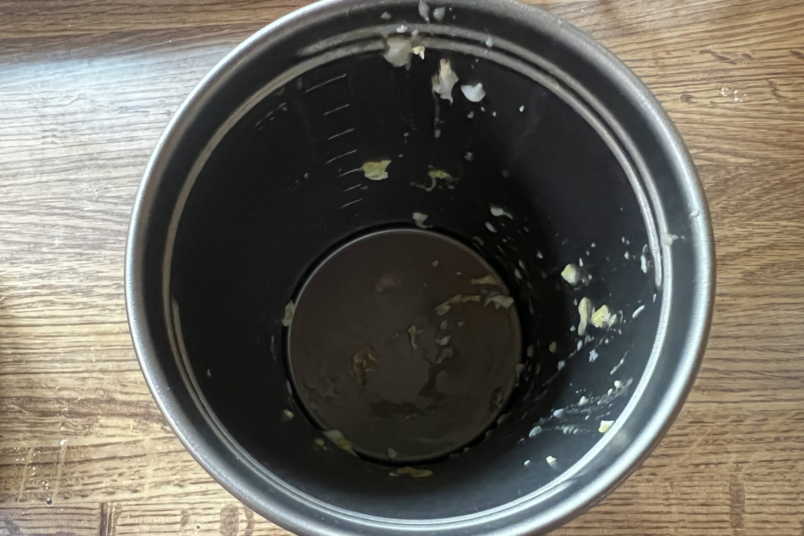 A top down view of a pot with pieces of egg in it.
