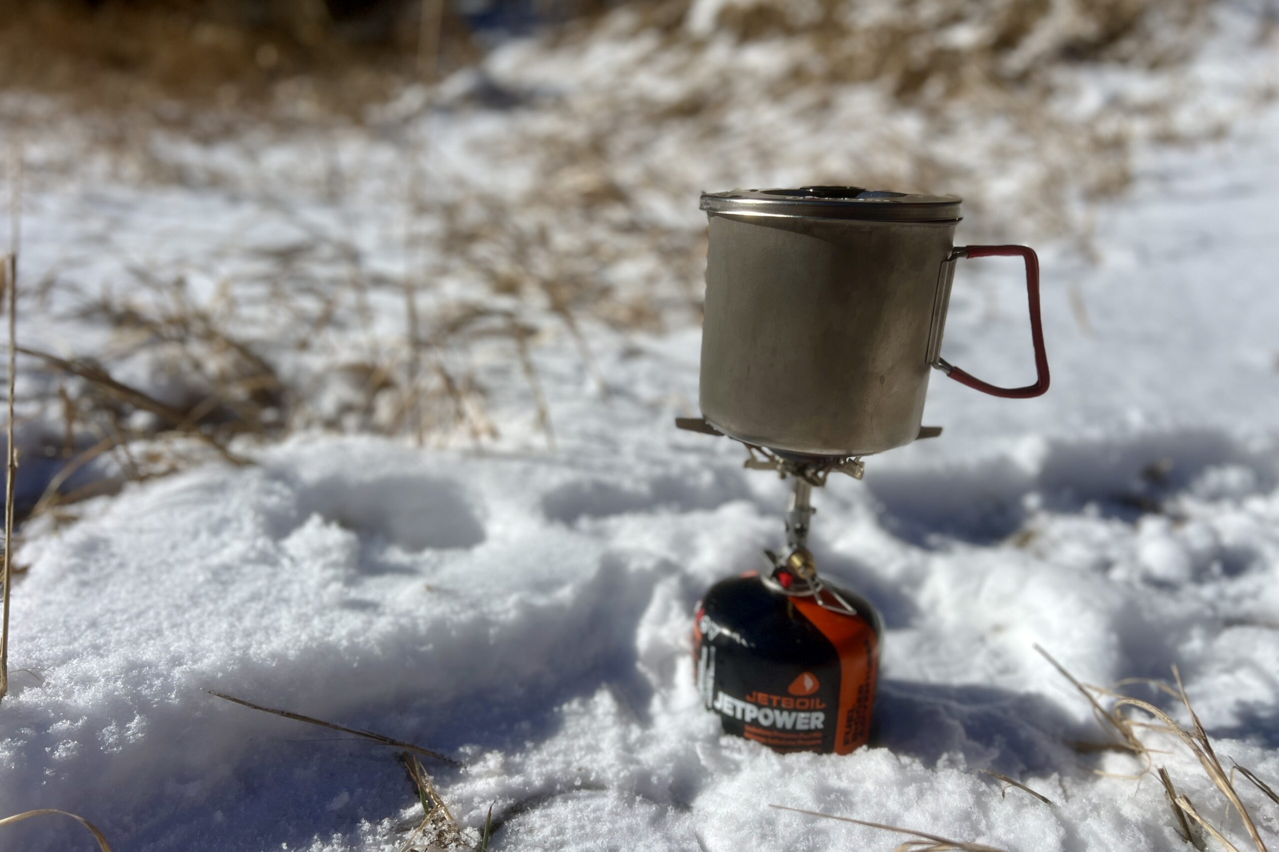 The evernew pasta pot sitting on a cook stove with a snowy background.