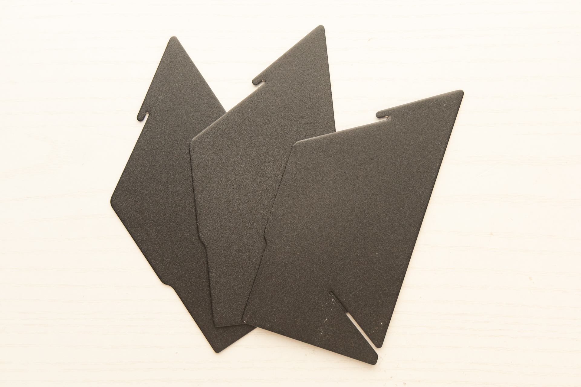 The MiiR Porigami unassembled: three identical metal pieces lay flat.