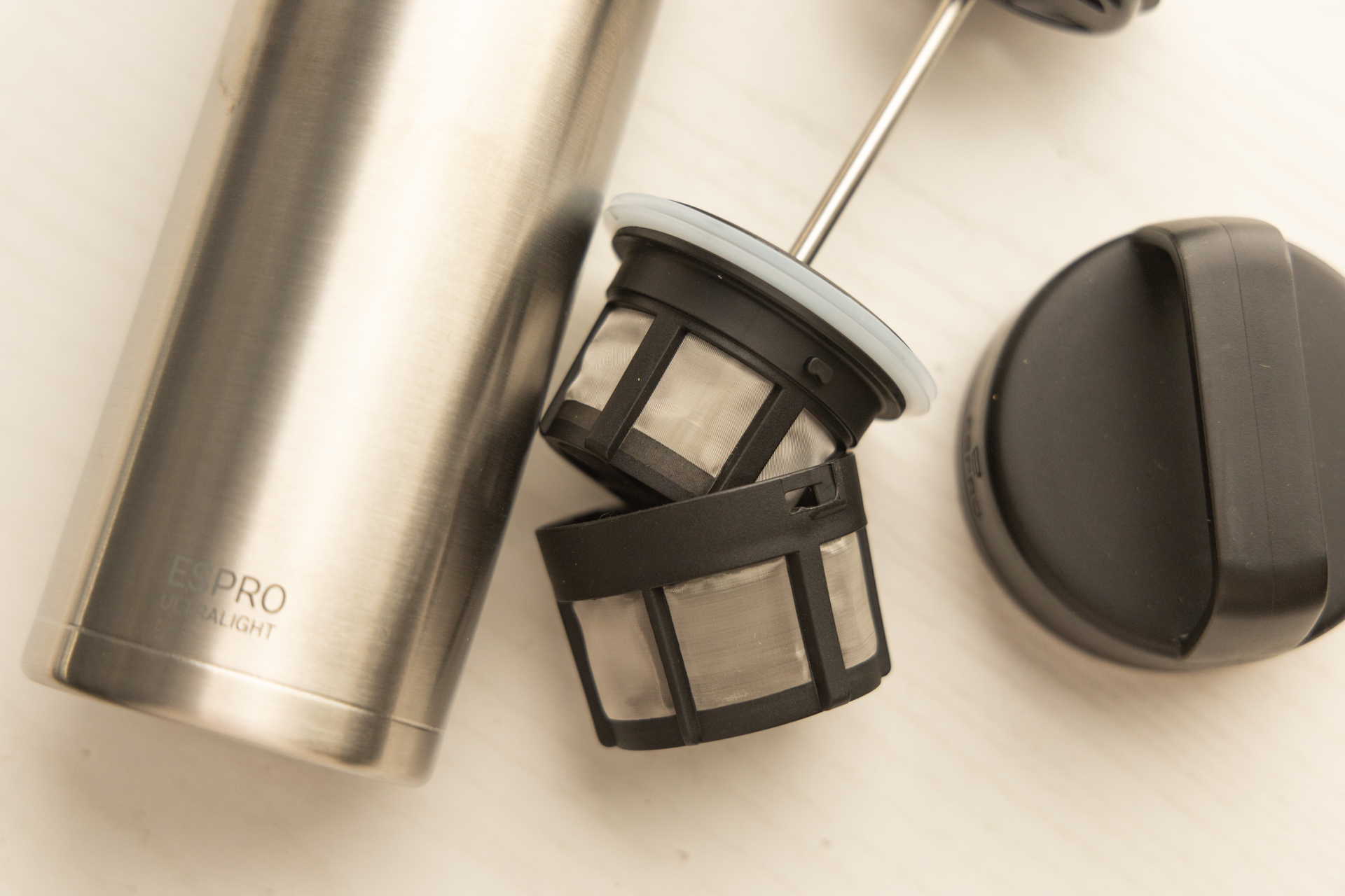 The ESPRO Filter and lid. The filter is disassembled into two parts.