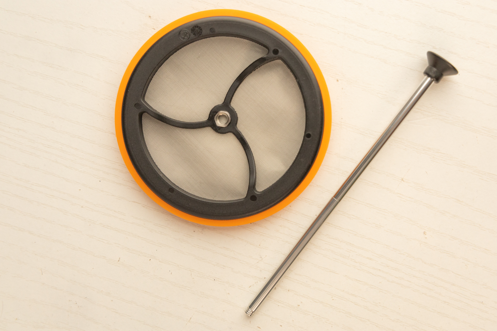 The Jetboil Silicone Coffee Press in two parts: the filter disconnected from the plunger arm.