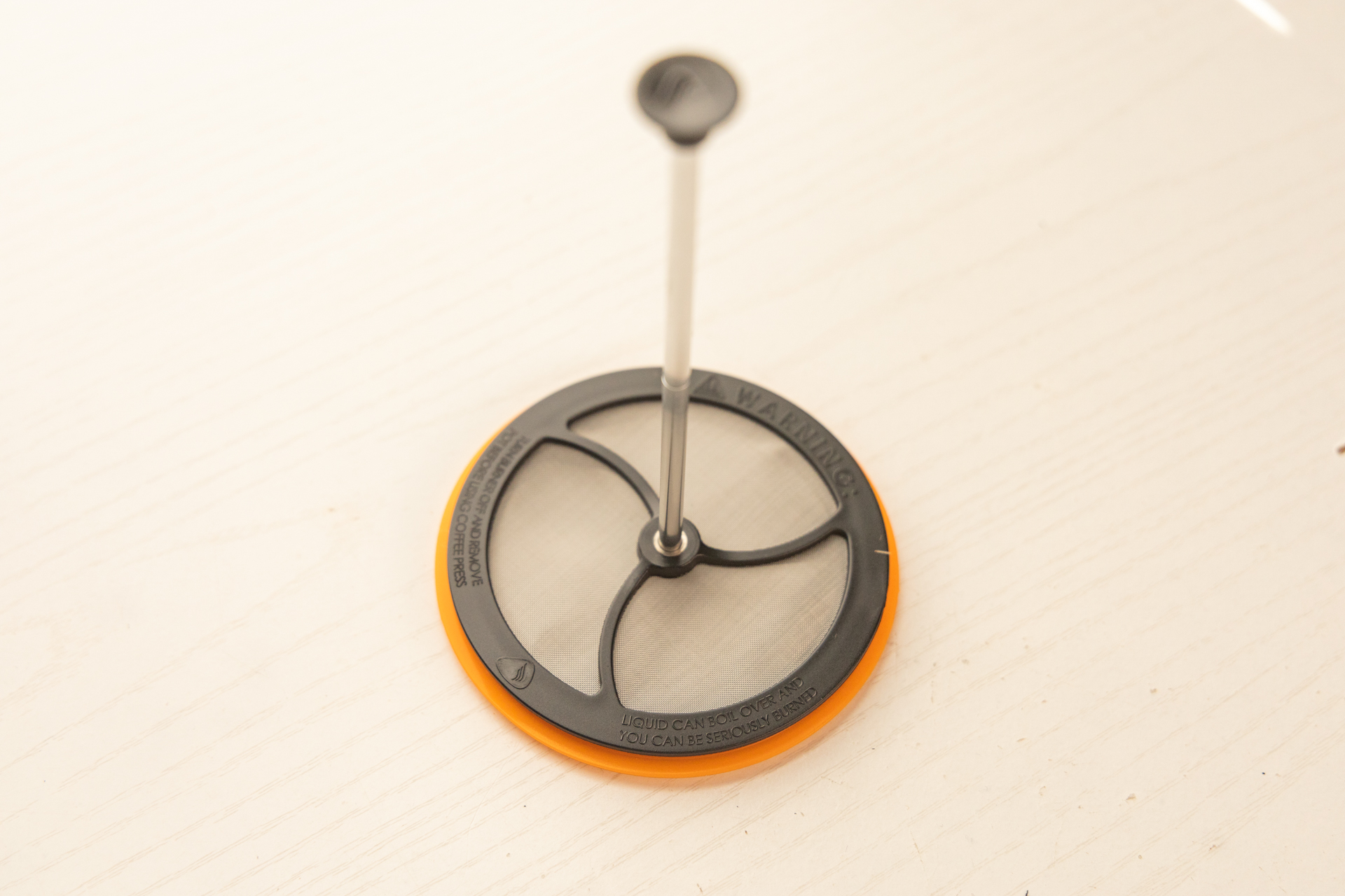 The Jetboil Silicone Coffee Press accessory consists of a lid, filter, and plunger.