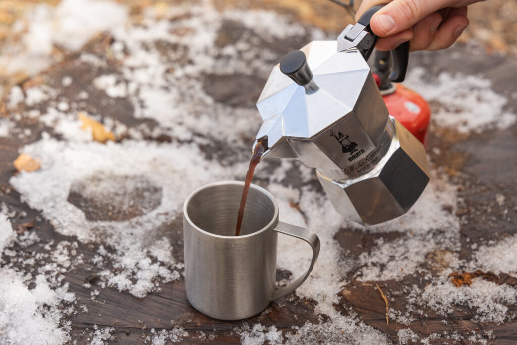 Pouring coffee into a mug from the Bialetti Moka Express.